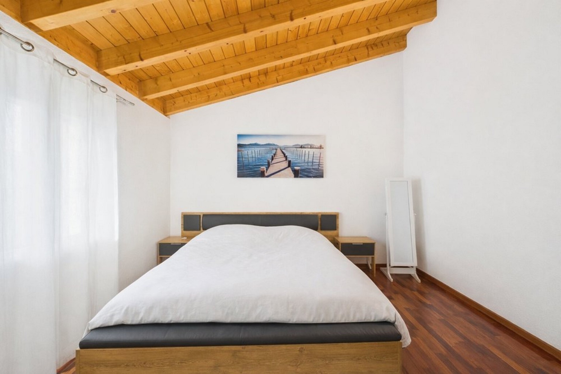 Helles Schlafzimmer mit Holzbalkendecke
