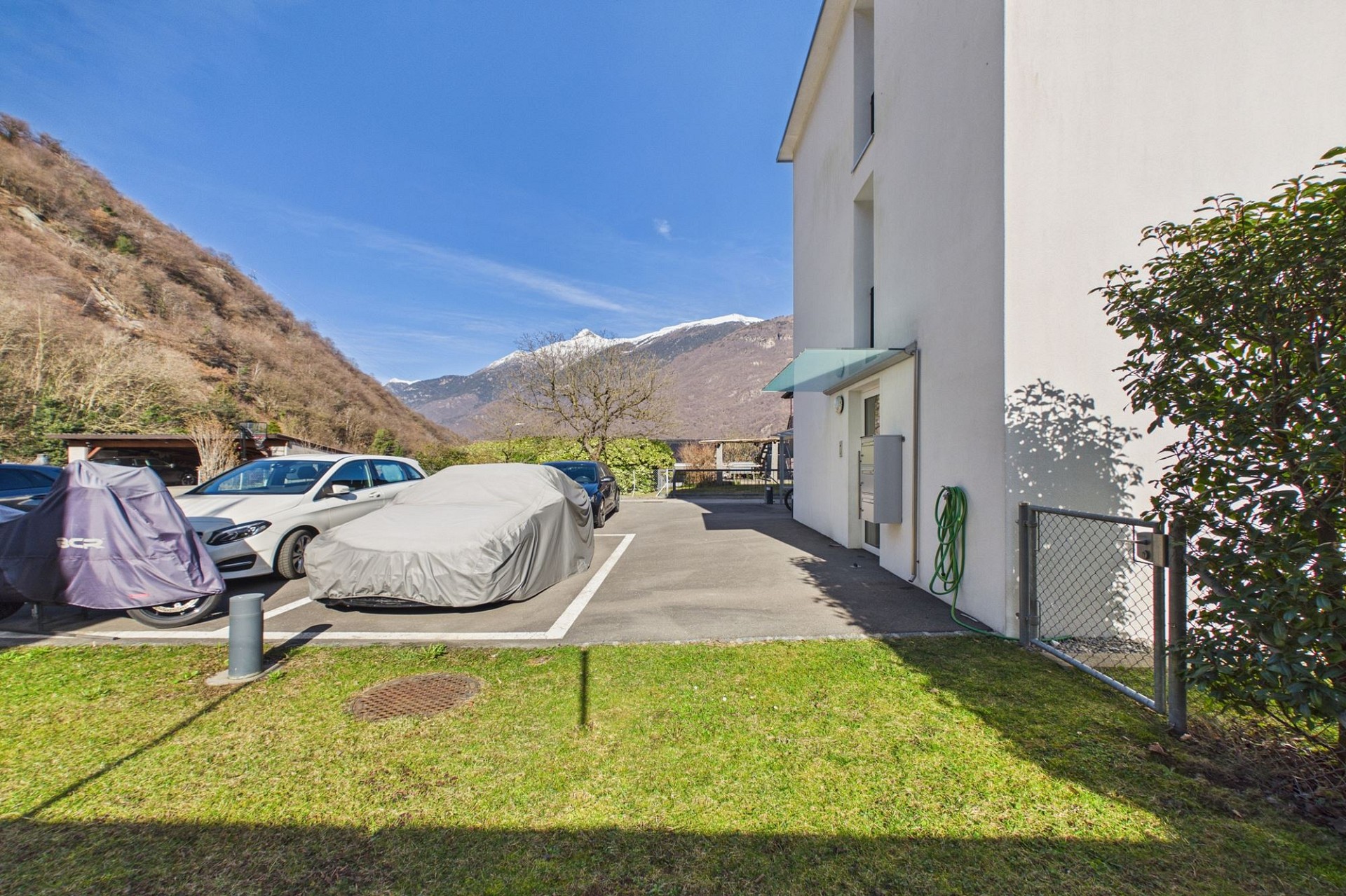 Außenansicht mit Parkplatz und Bergkulisse