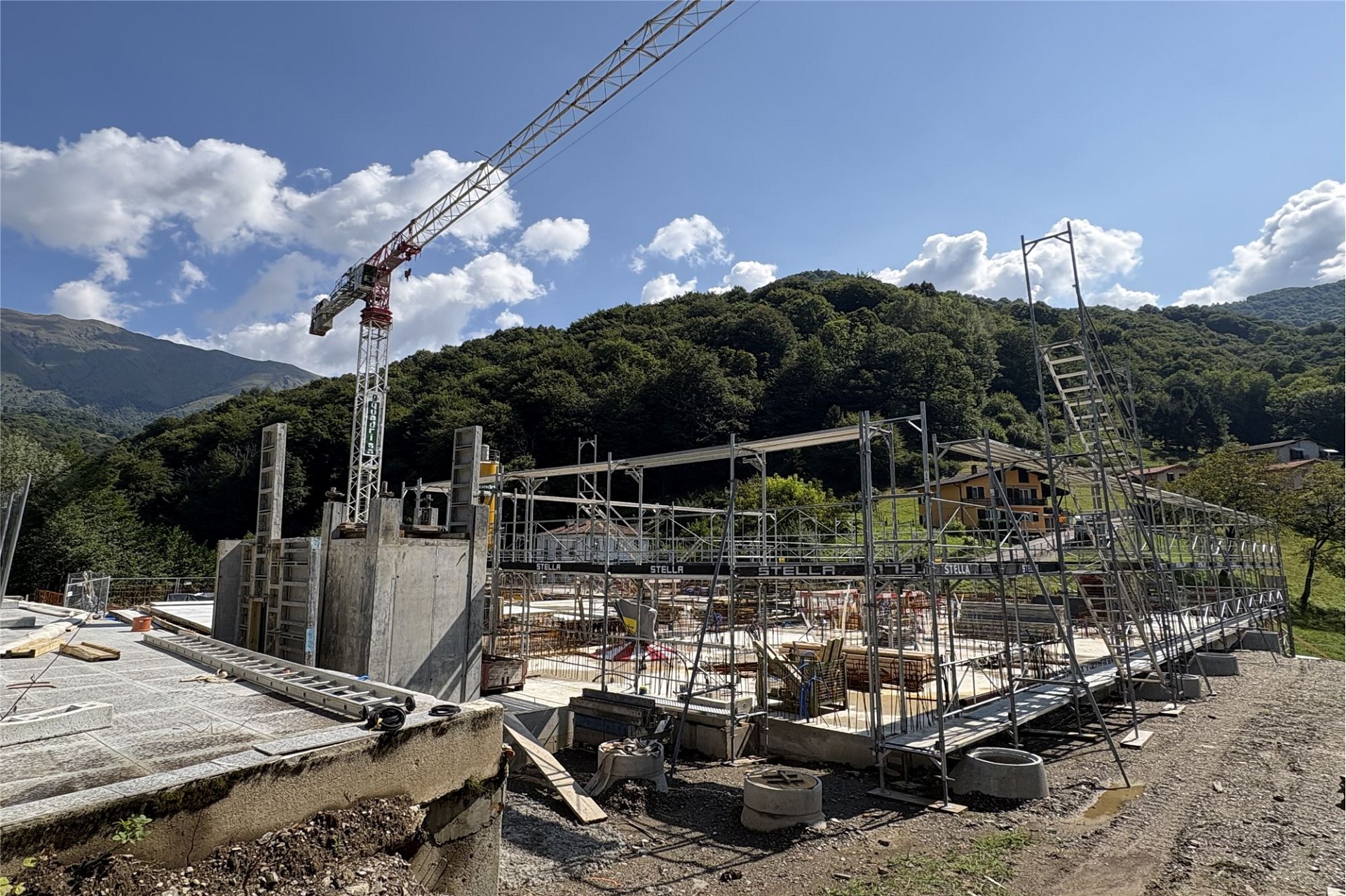 Baustelle im Gebirge mit Kran und Gerüst
