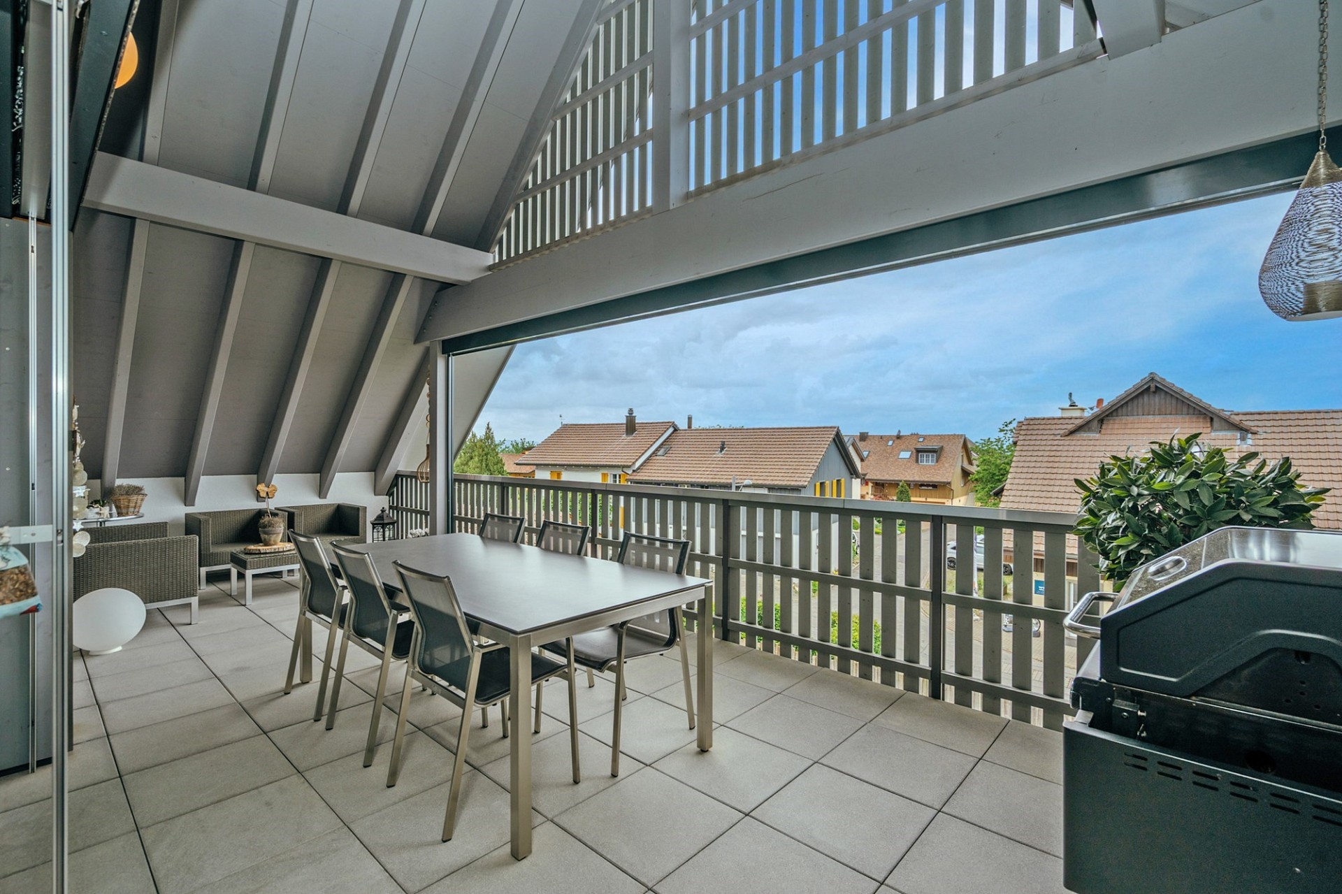 Überdachte Terrasse mit Essbereich und Grill