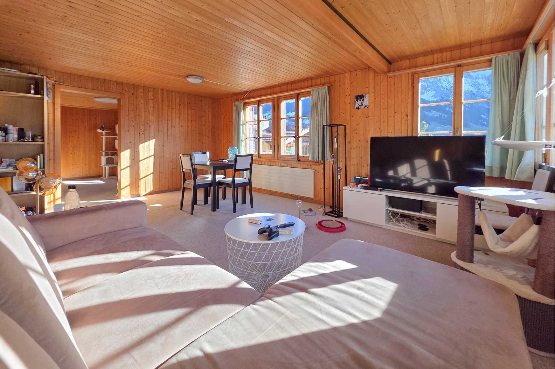 Gemütliches Wohnzimmer in Holzoptik mit Bergblick