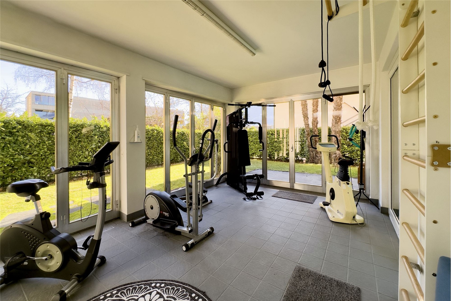 Heller Fitnessraum mit Gartenblick