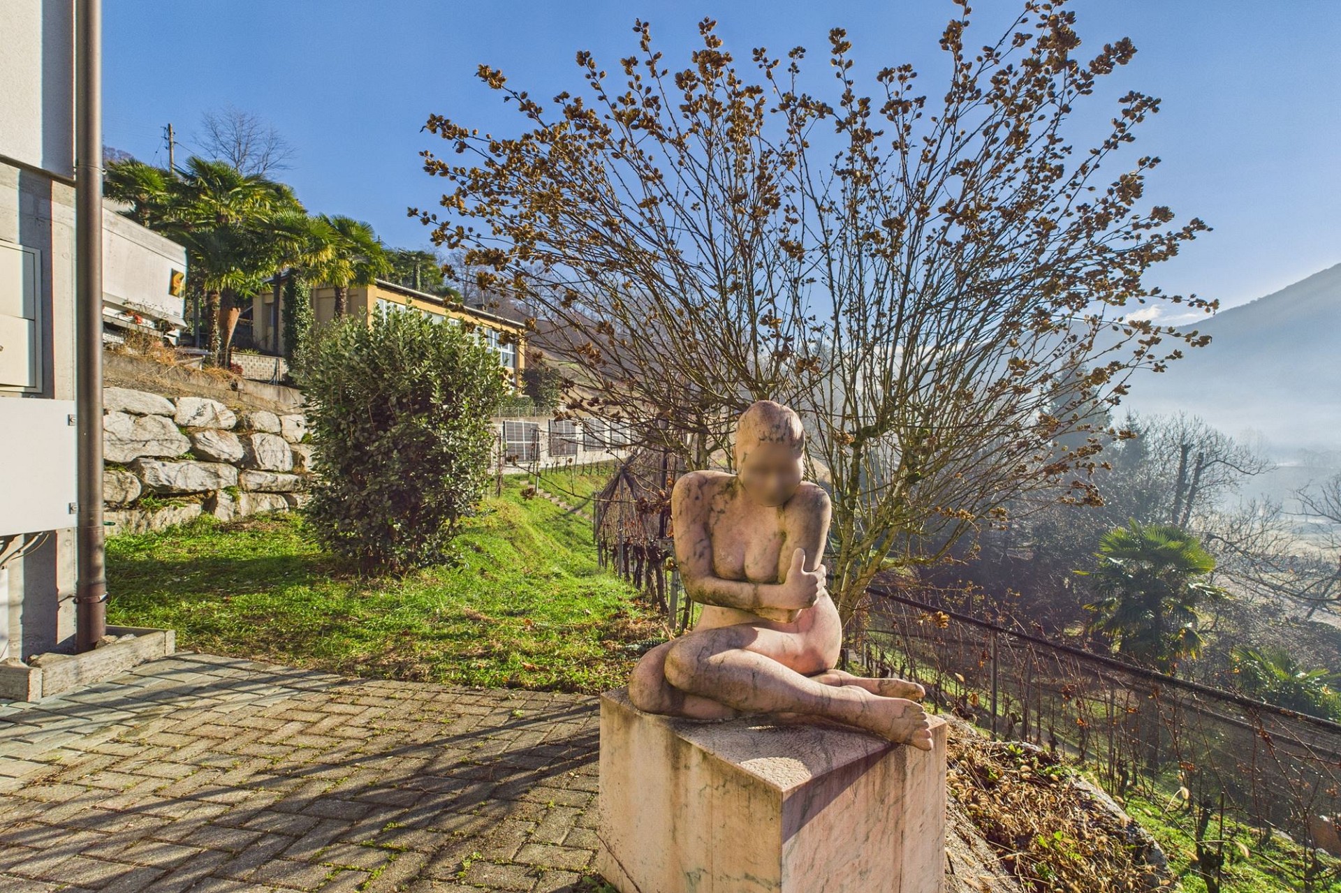 Garten- und Terrassenbereich mit Skulptur