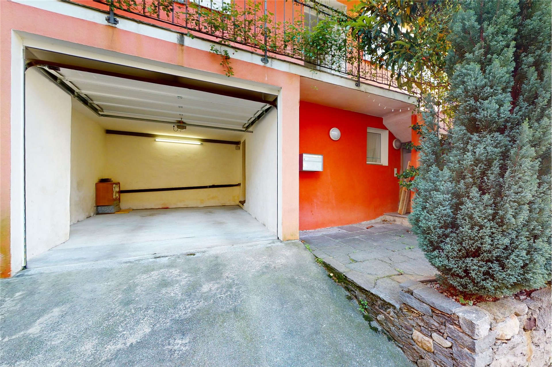 Außenansicht einer Garage mit Einfahrt und Vorplatz