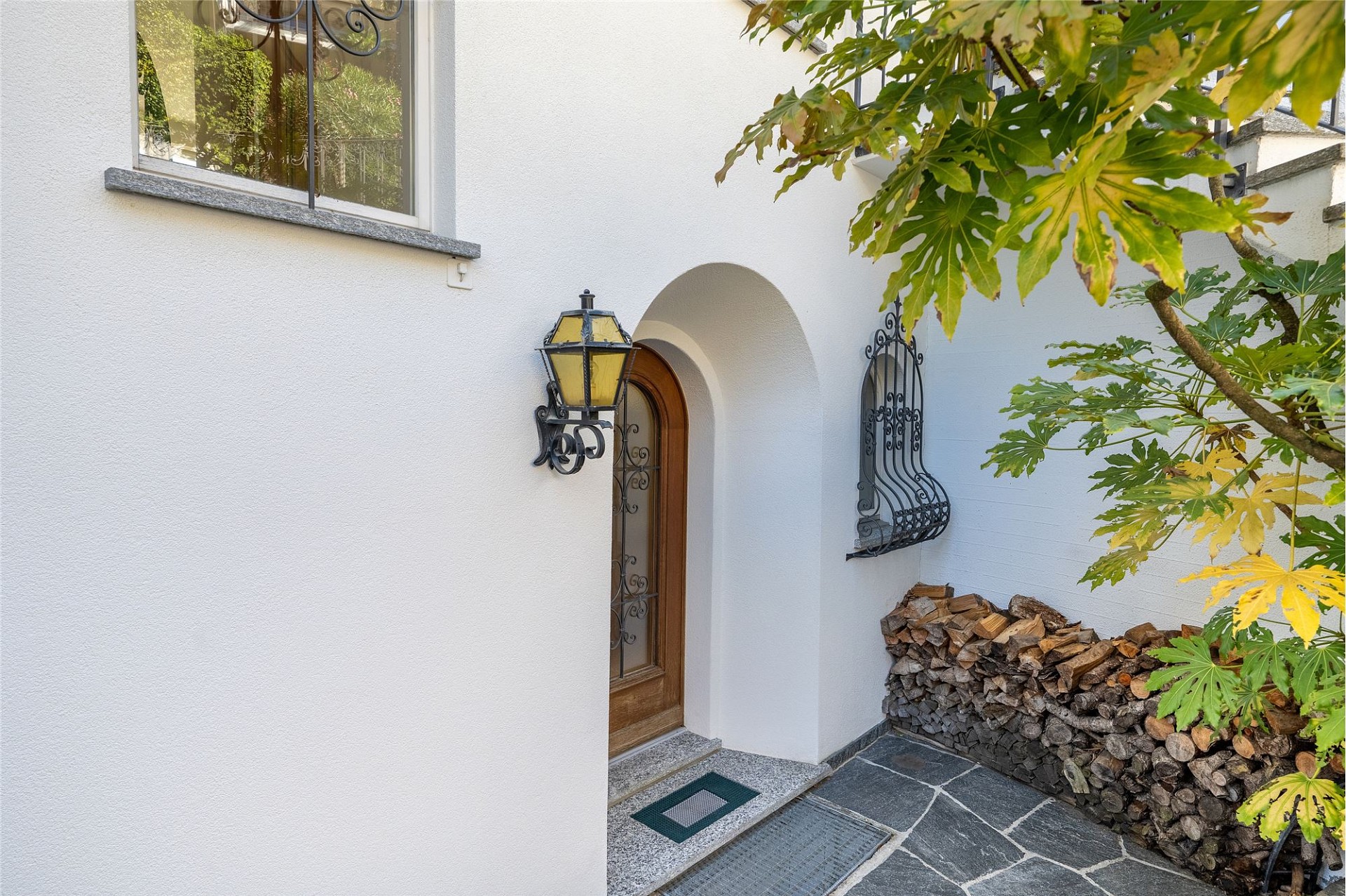 Hauseingang mit weißer Fassade und dekorativen Details