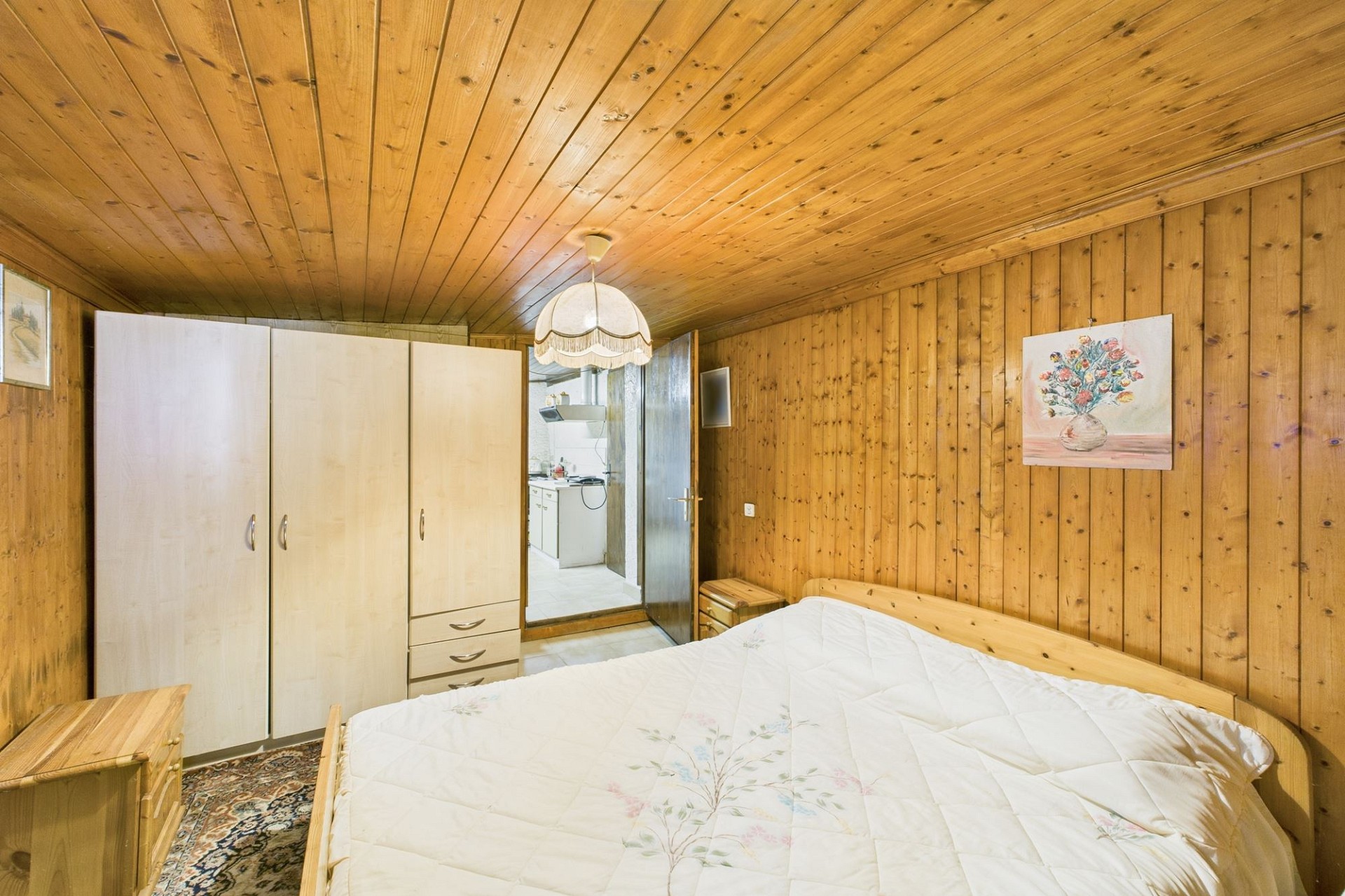 Rustikales Schlafzimmer mit Holzvertäfelung
