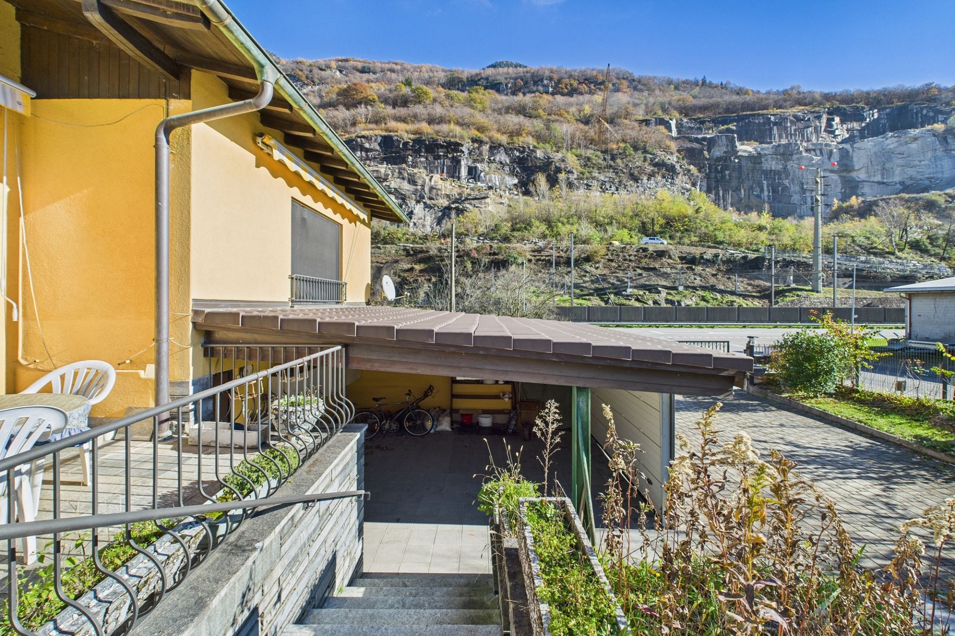 Außenansicht einer Terrasse mit Garage und Bergblick