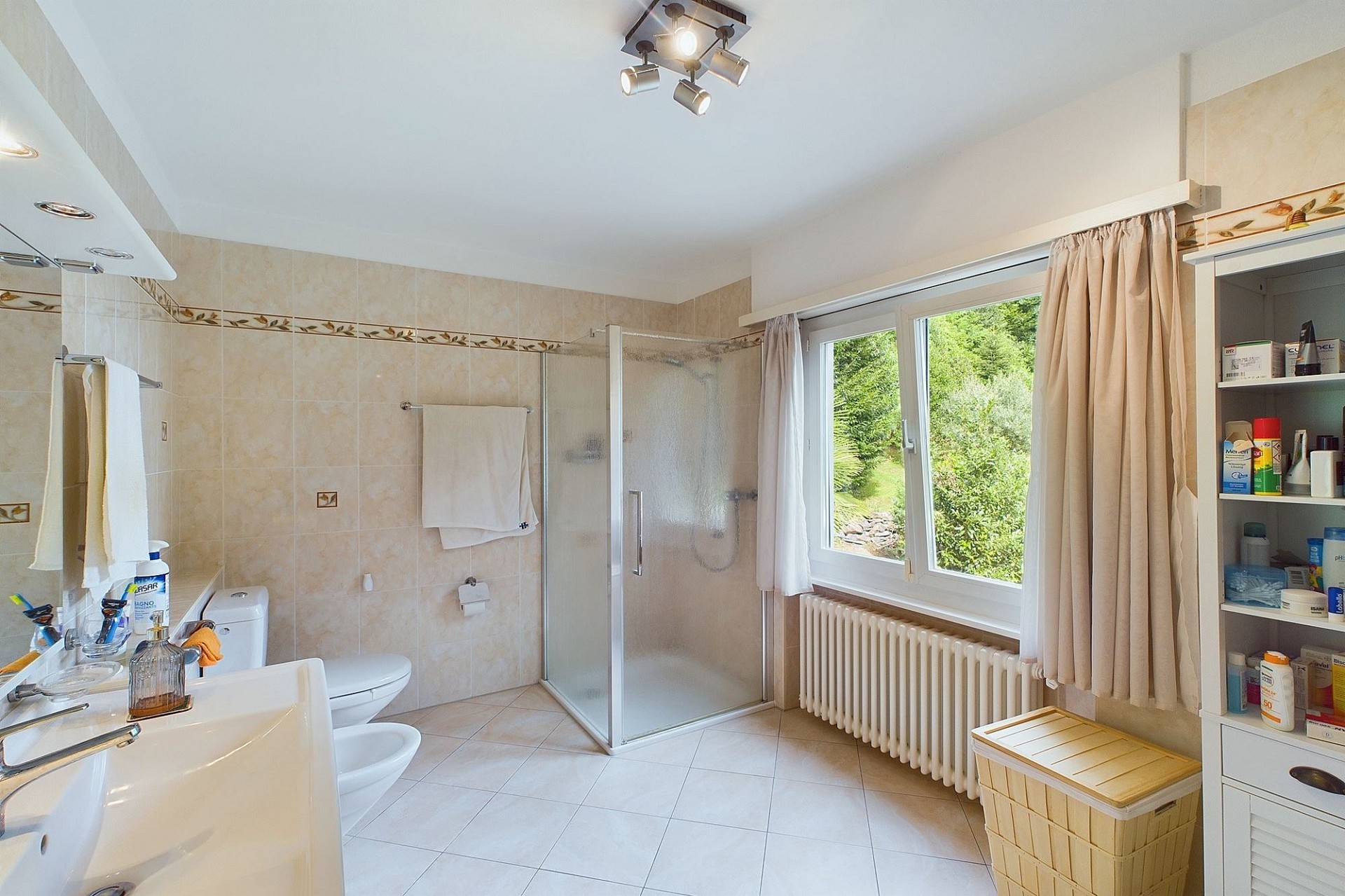 Helles Badezimmer mit Dusche und Fensterblick