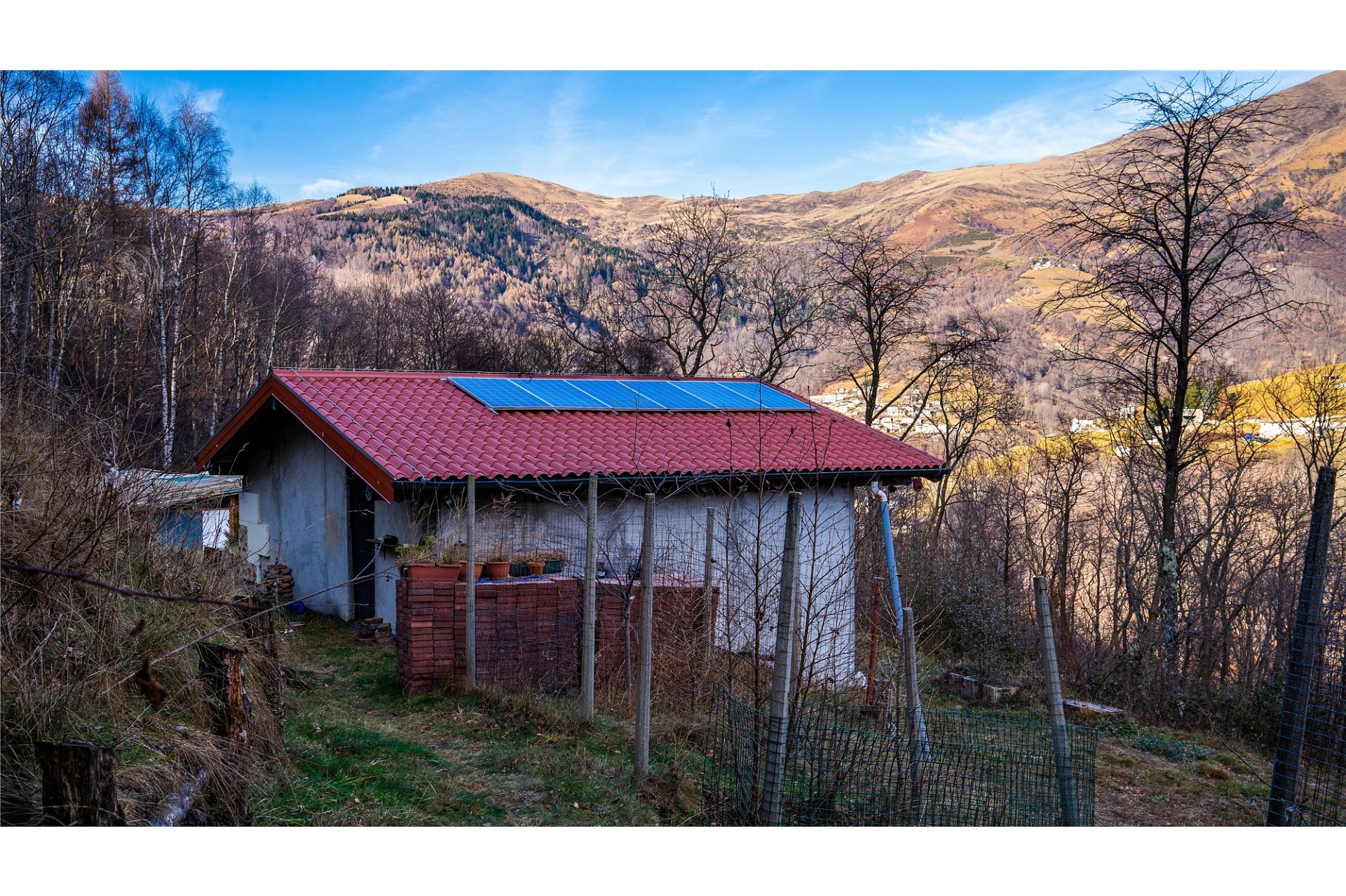 Ländliches Haus mit rotem Ziegeldach und Bergblick