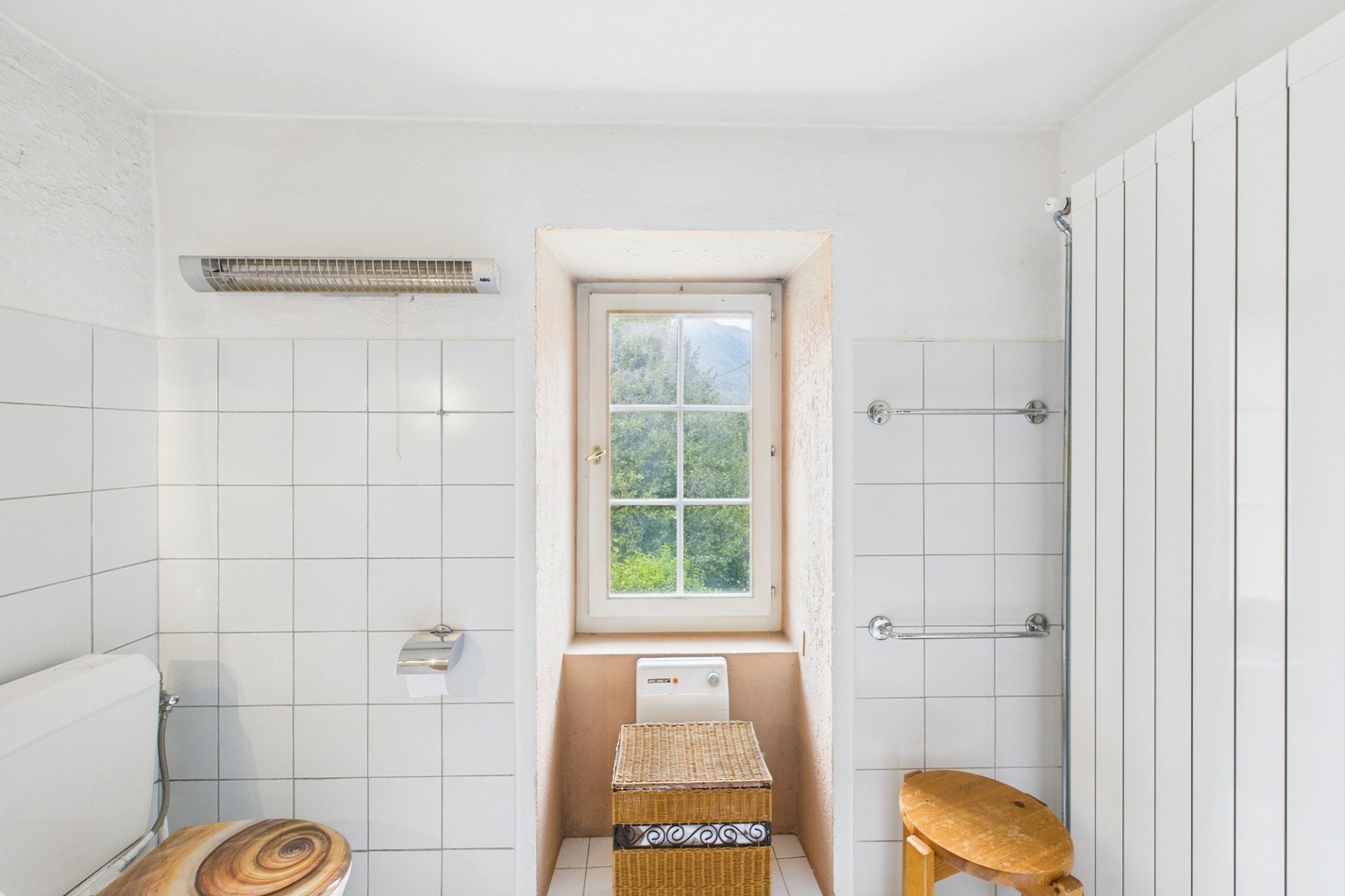 Helles, schlichtes Badezimmer mit Fenster und Holzdetails