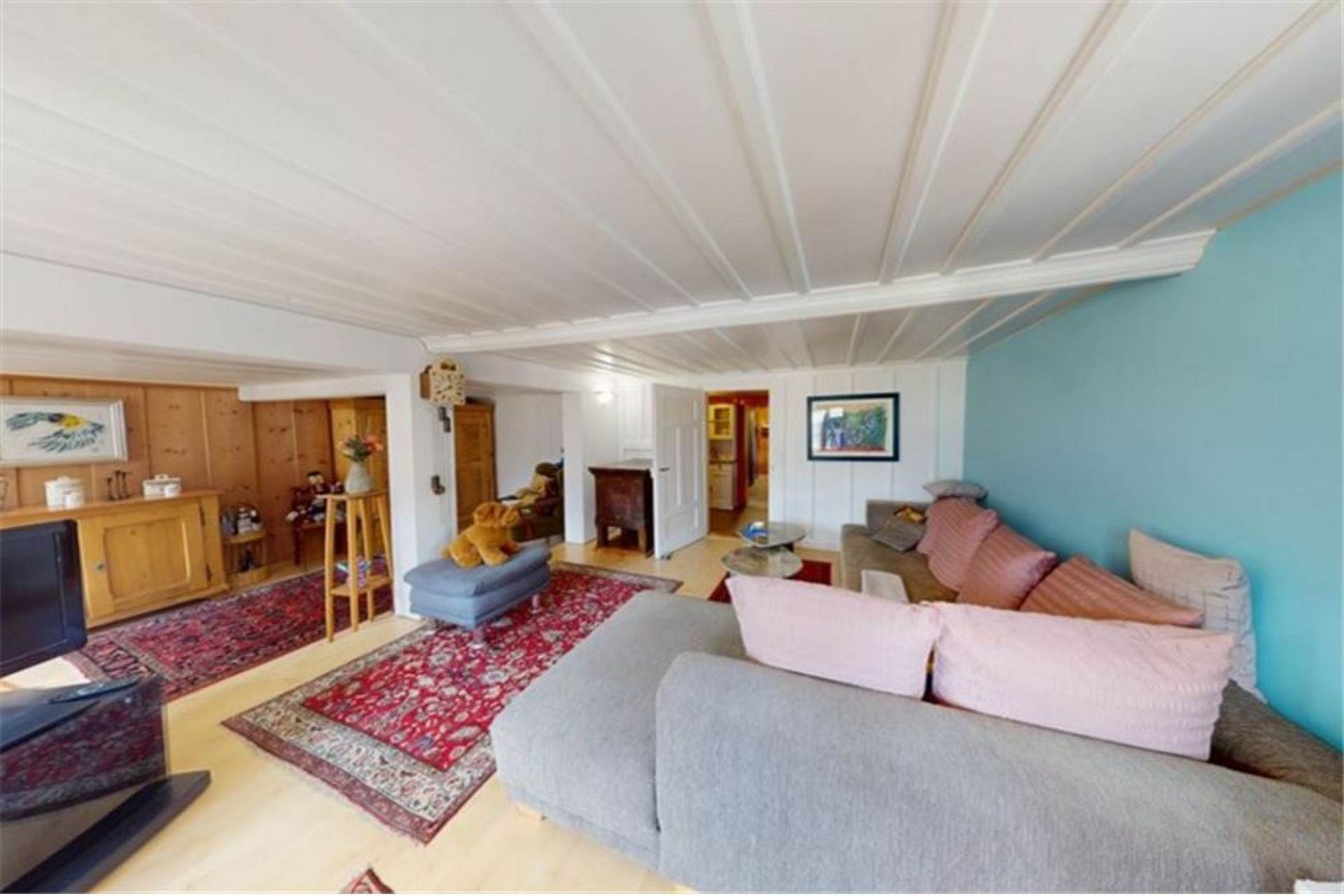 Gemütliches Wohnzimmer mit Sitzbereich und Holzvertäfelung