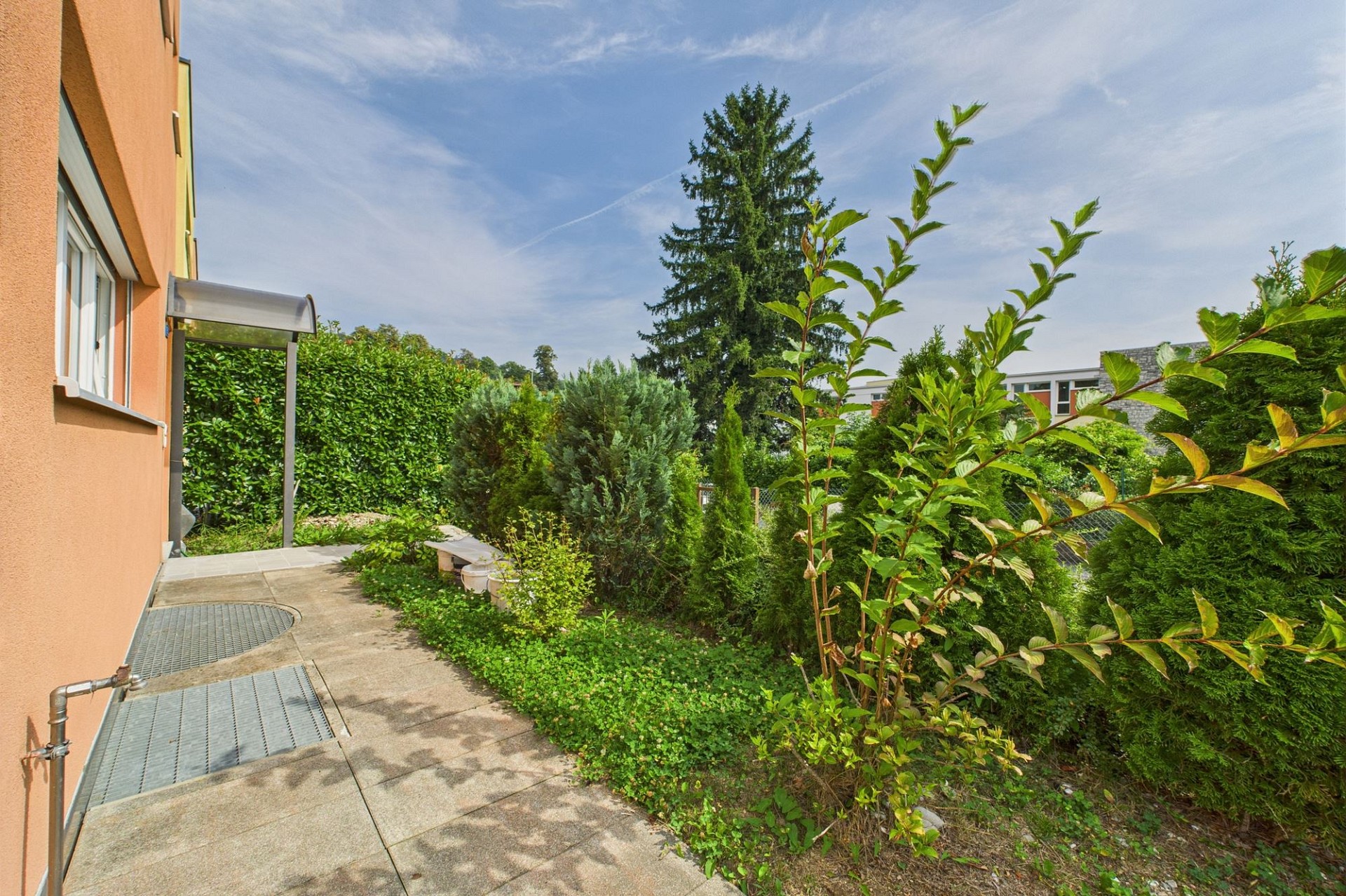Gartenansicht mit Hausfassade und Terrasse