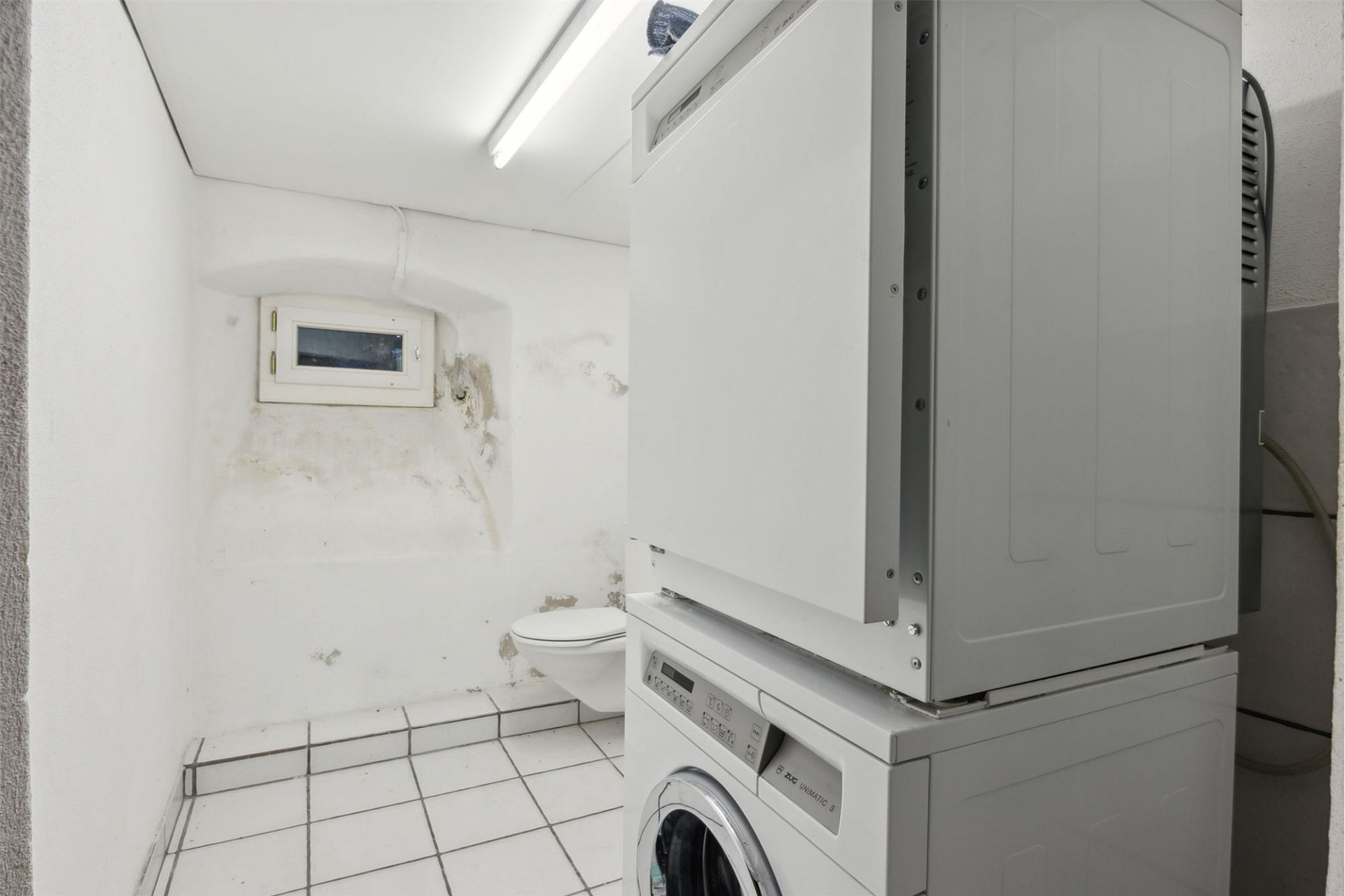 Kleiner Hauswirtschafts- bzw. Badraum mit Waschmaschine und WC