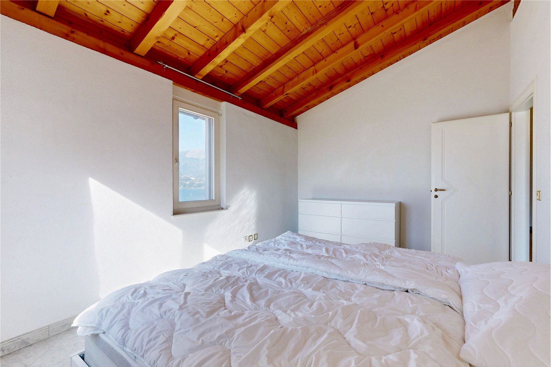 Helles Schlafzimmer mit Holzbalkendecke
