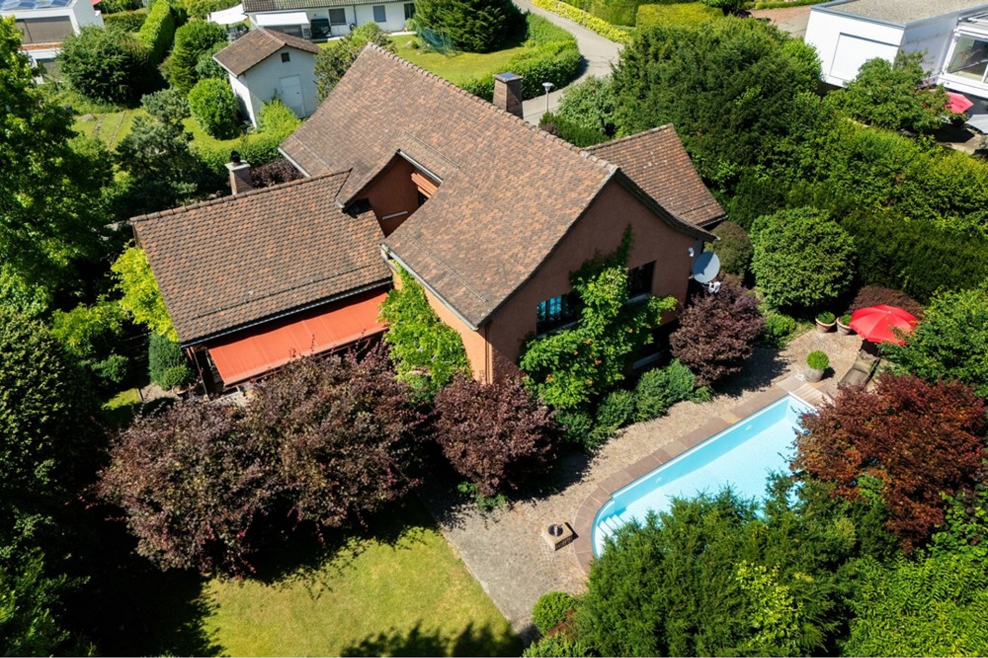 Luftaufnahme eines Hauses mit Garten und Pool