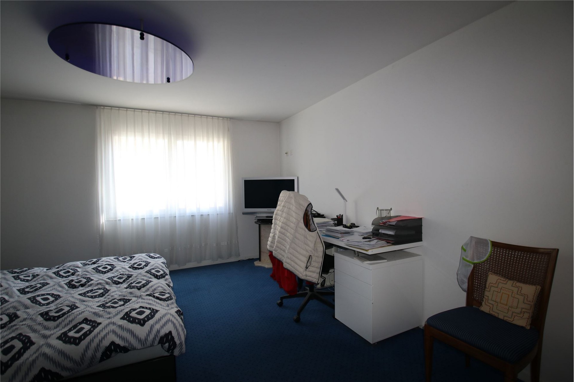 Schlichtes Schlafzimmer mit Arbeitsbereich