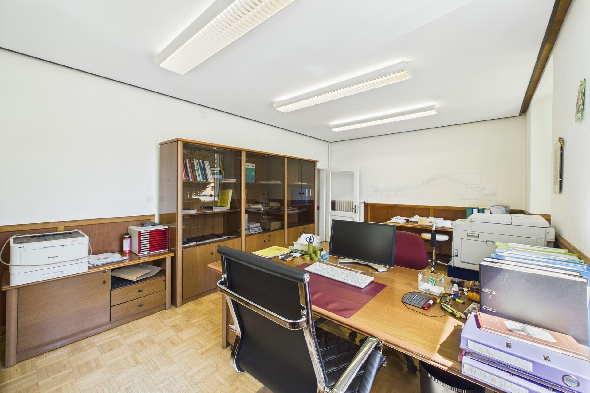 Büro mit Schreibtisch und Aktenschränken