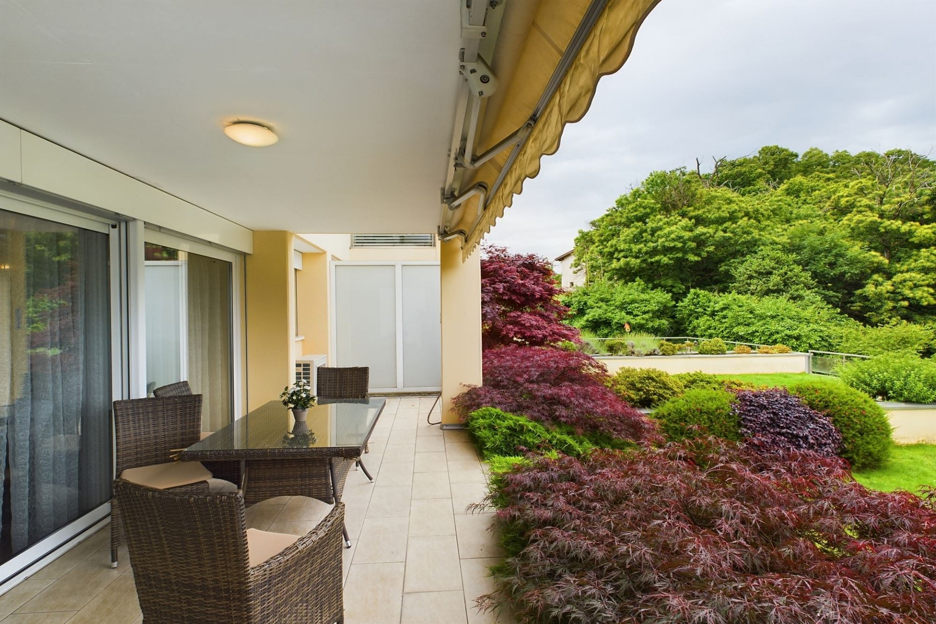 Überdachte Terrasse mit Gartenblick
