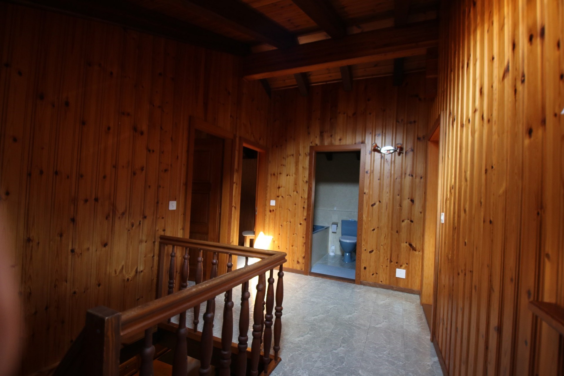 Holzvertäfelter Flur mit offenem Treppenbereich