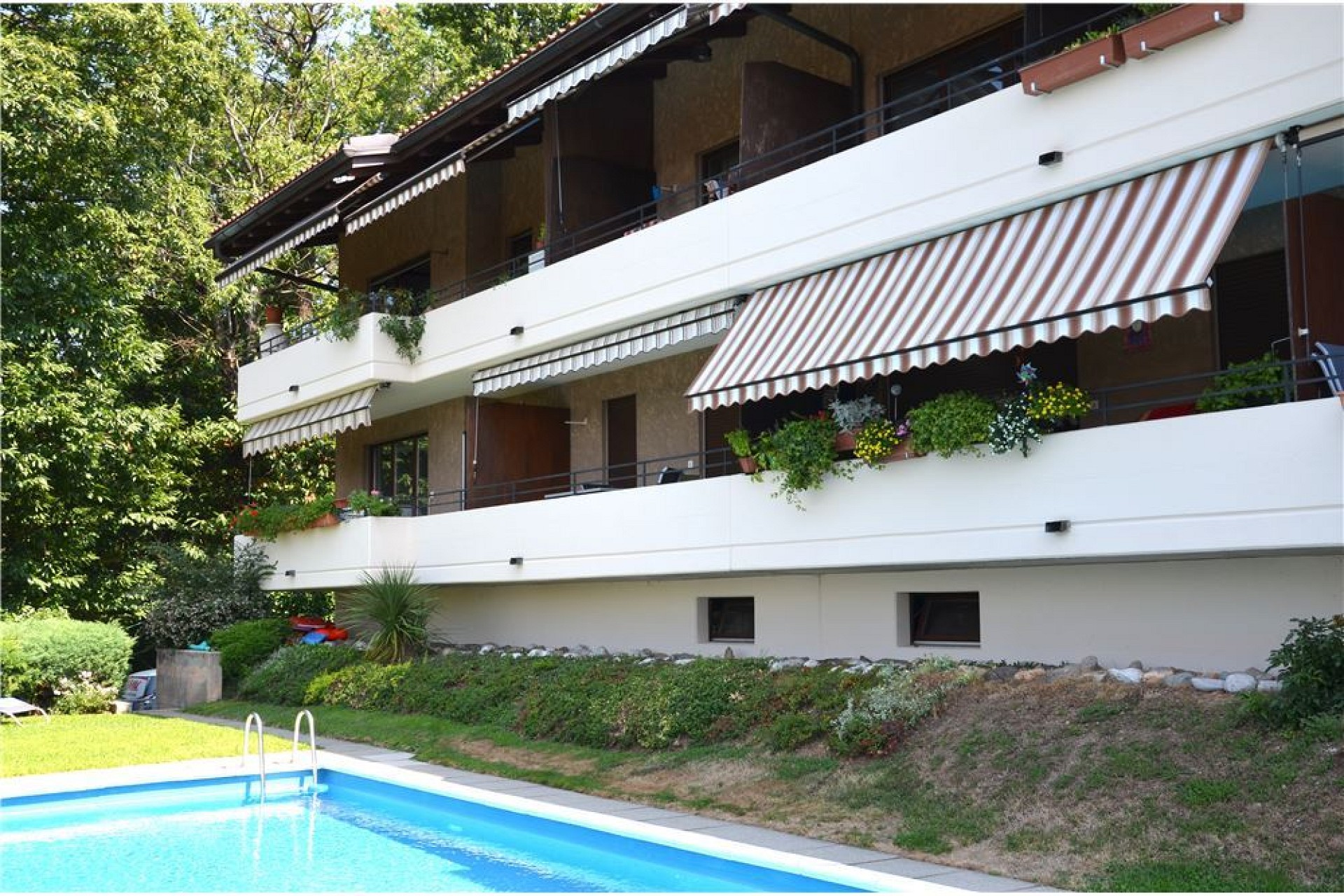 Wohnhaus mit Pool und Balkonen
