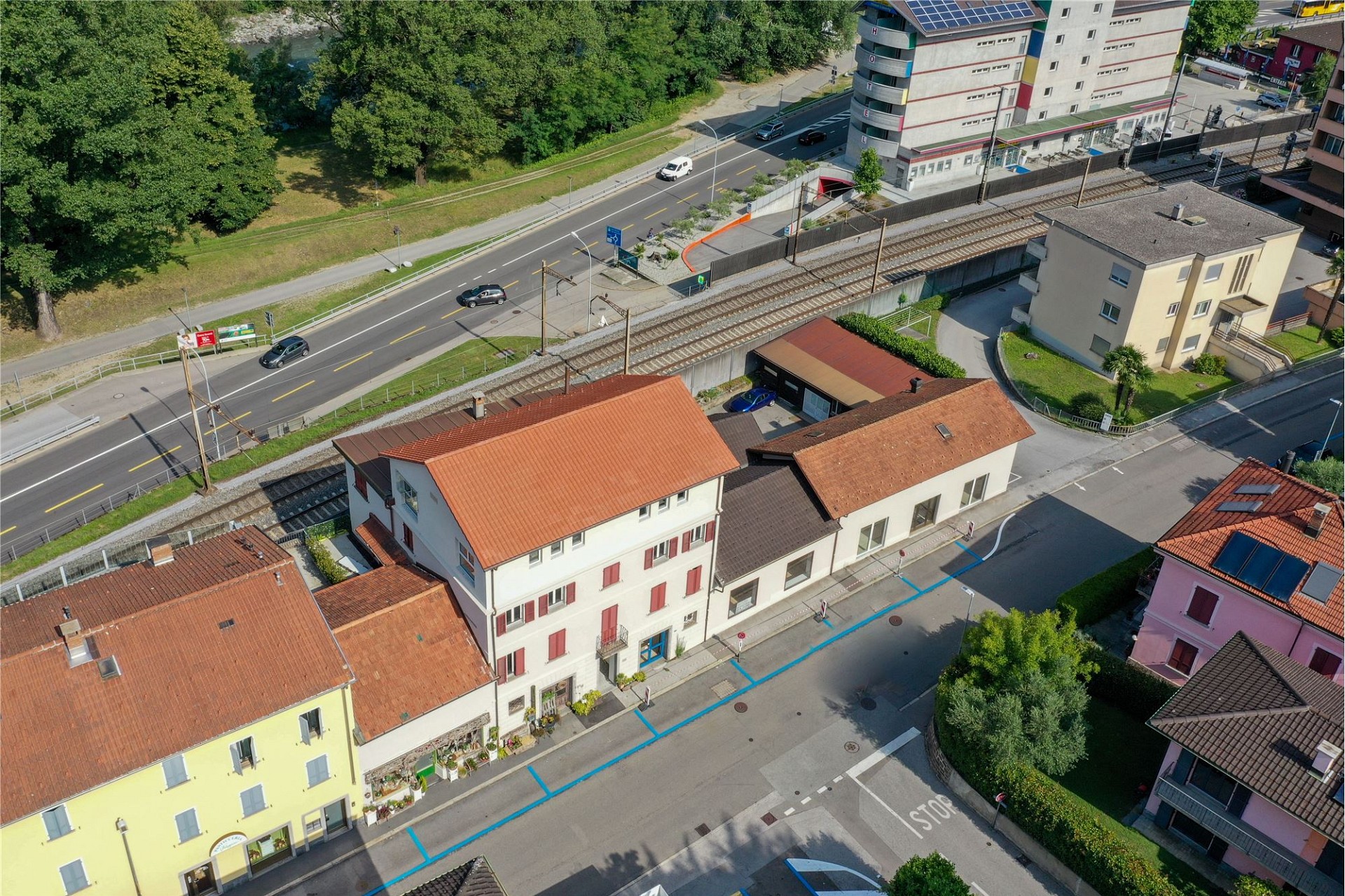 Luftaufnahme eines Wohn- und Straßenzugs an der Bahnlinie