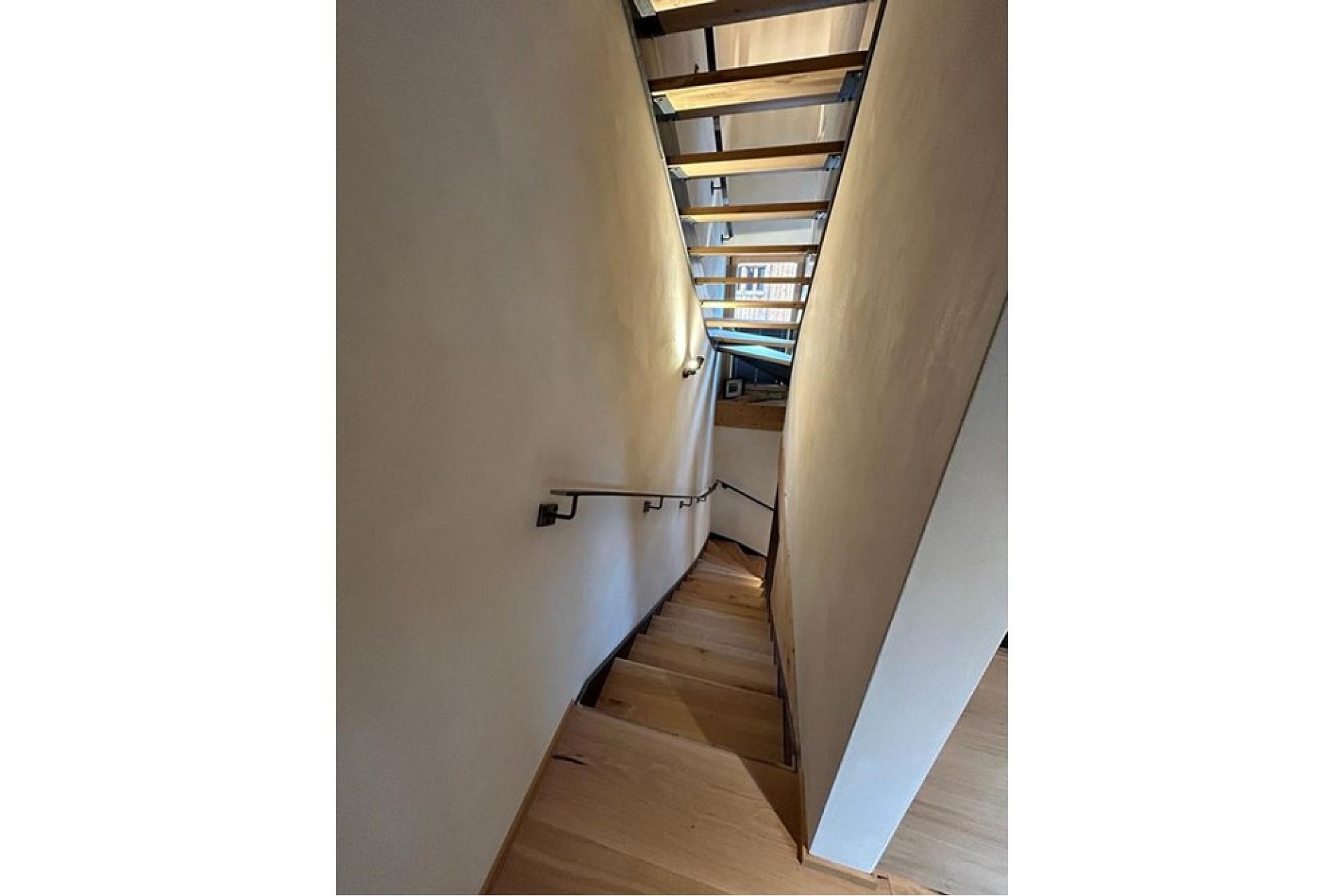 Treppenhaus mit schmaler Holztreppe