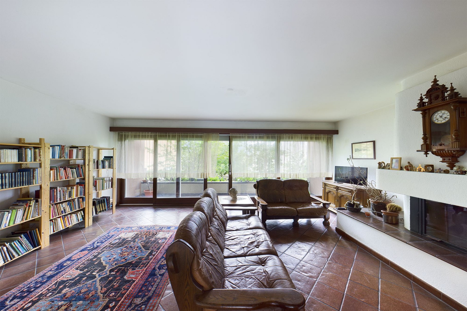 Wohnzimmer mit Kamin und Bücherregalen
