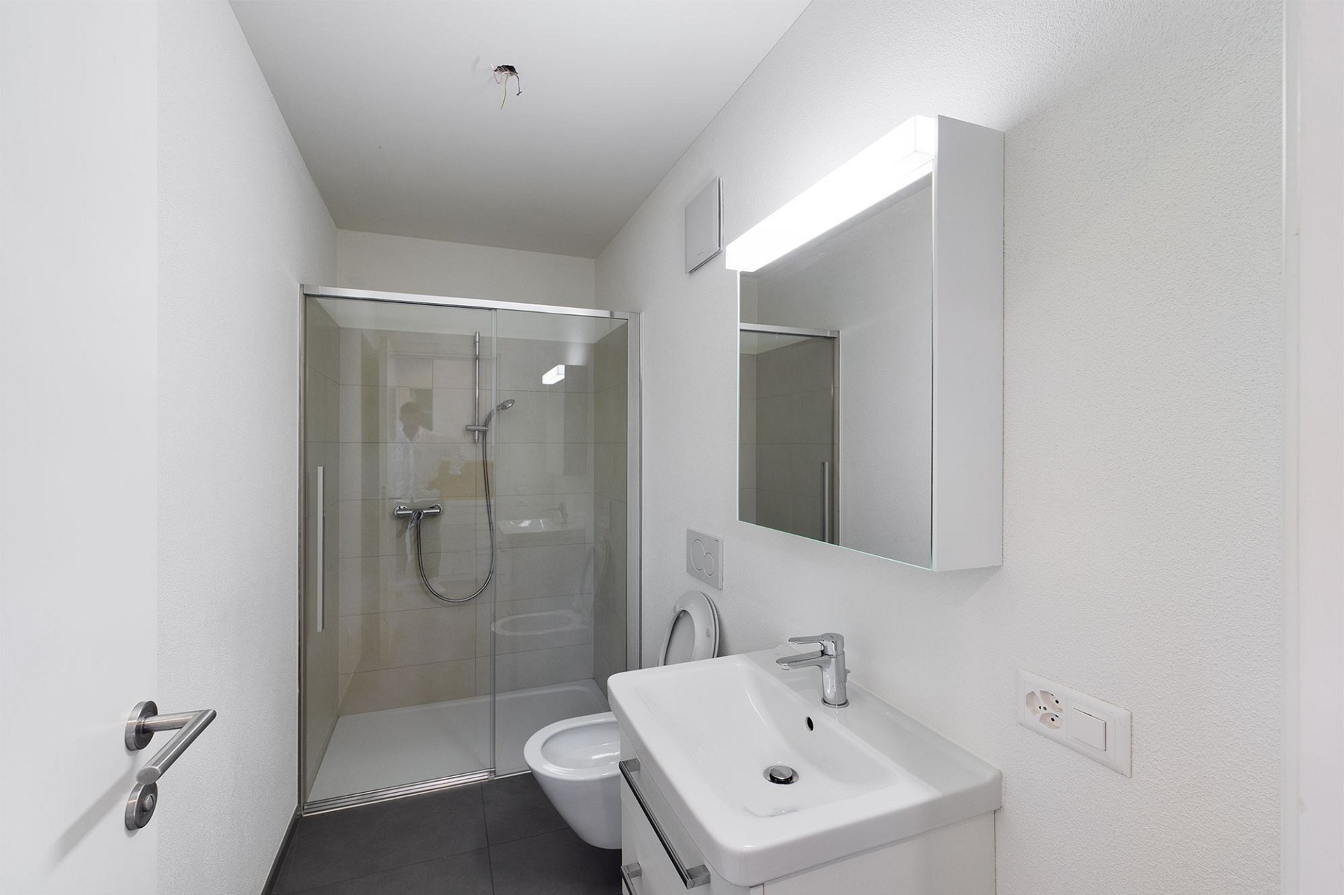 Modernes Bad mit Dusche und Waschbecken