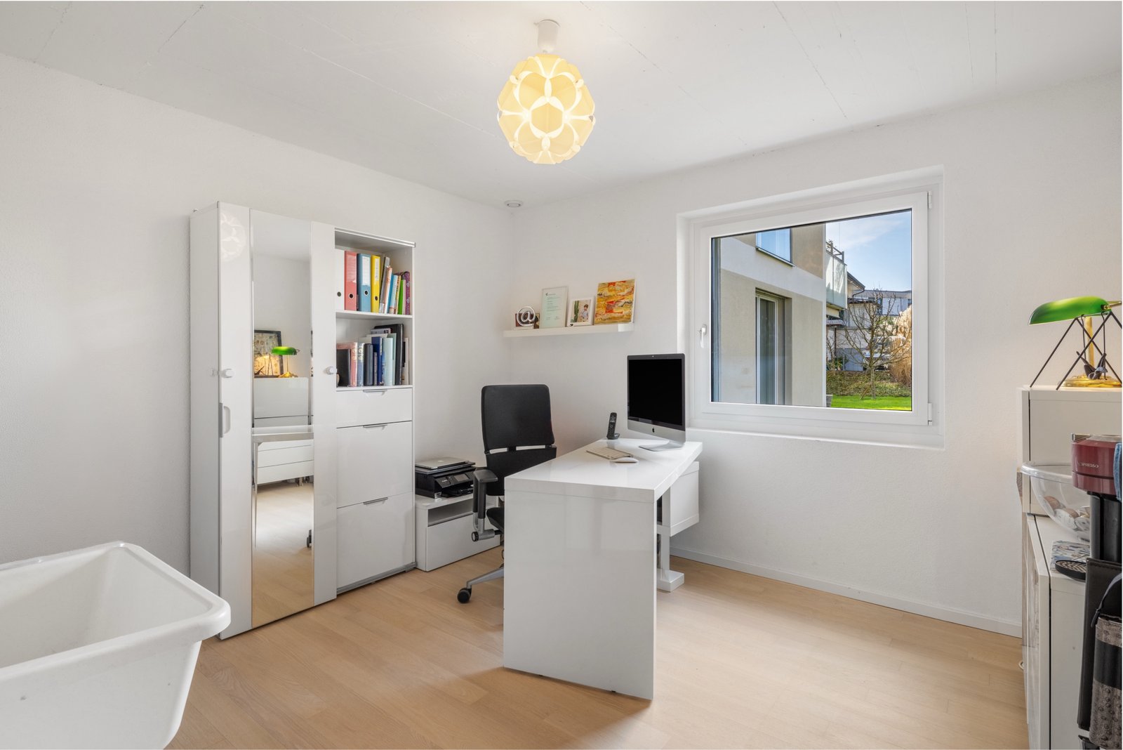 Helles Arbeitszimmer mit Schreibtisch und Fensterblick