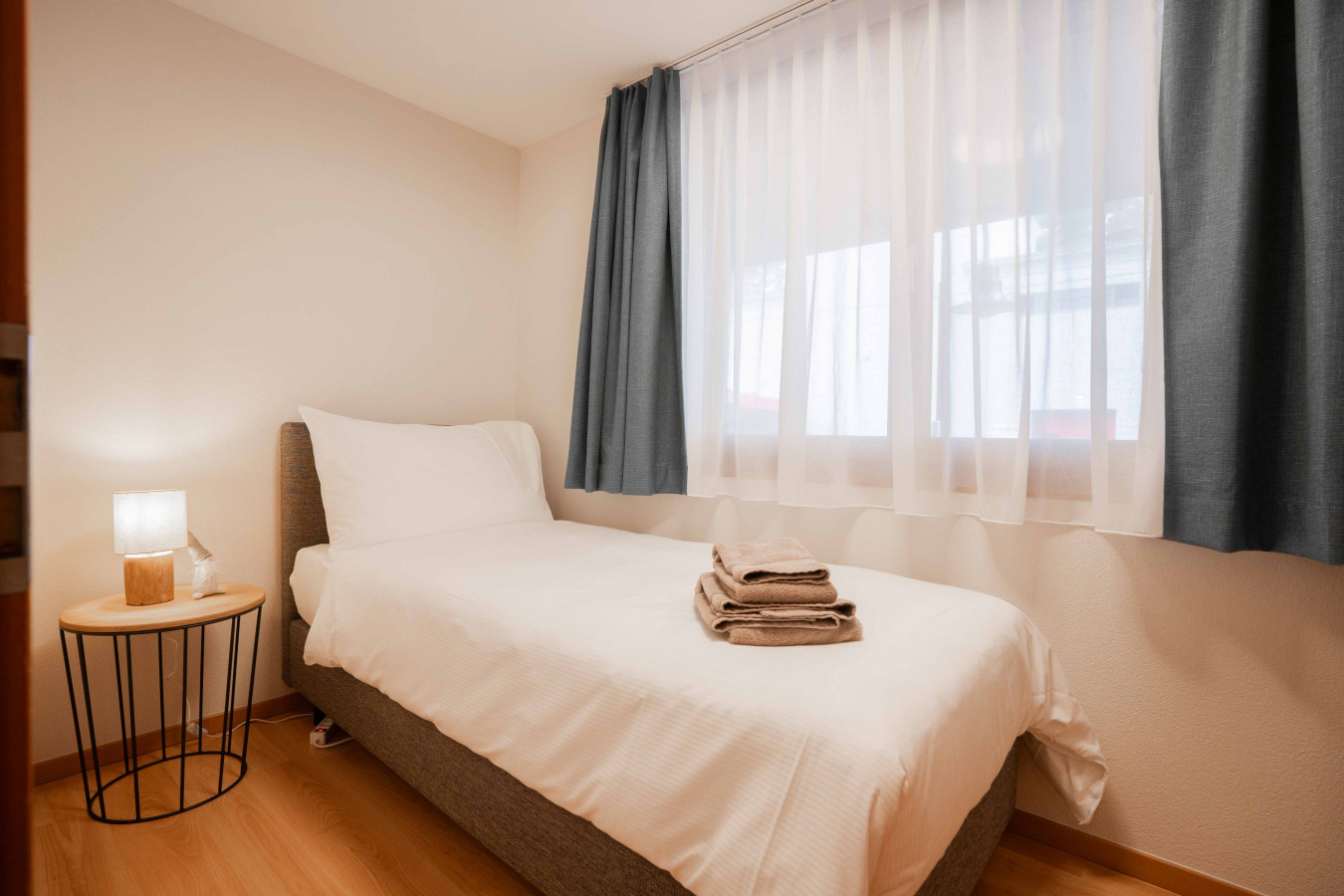 Helles Einzelzimmer mit Bett und Fenster
