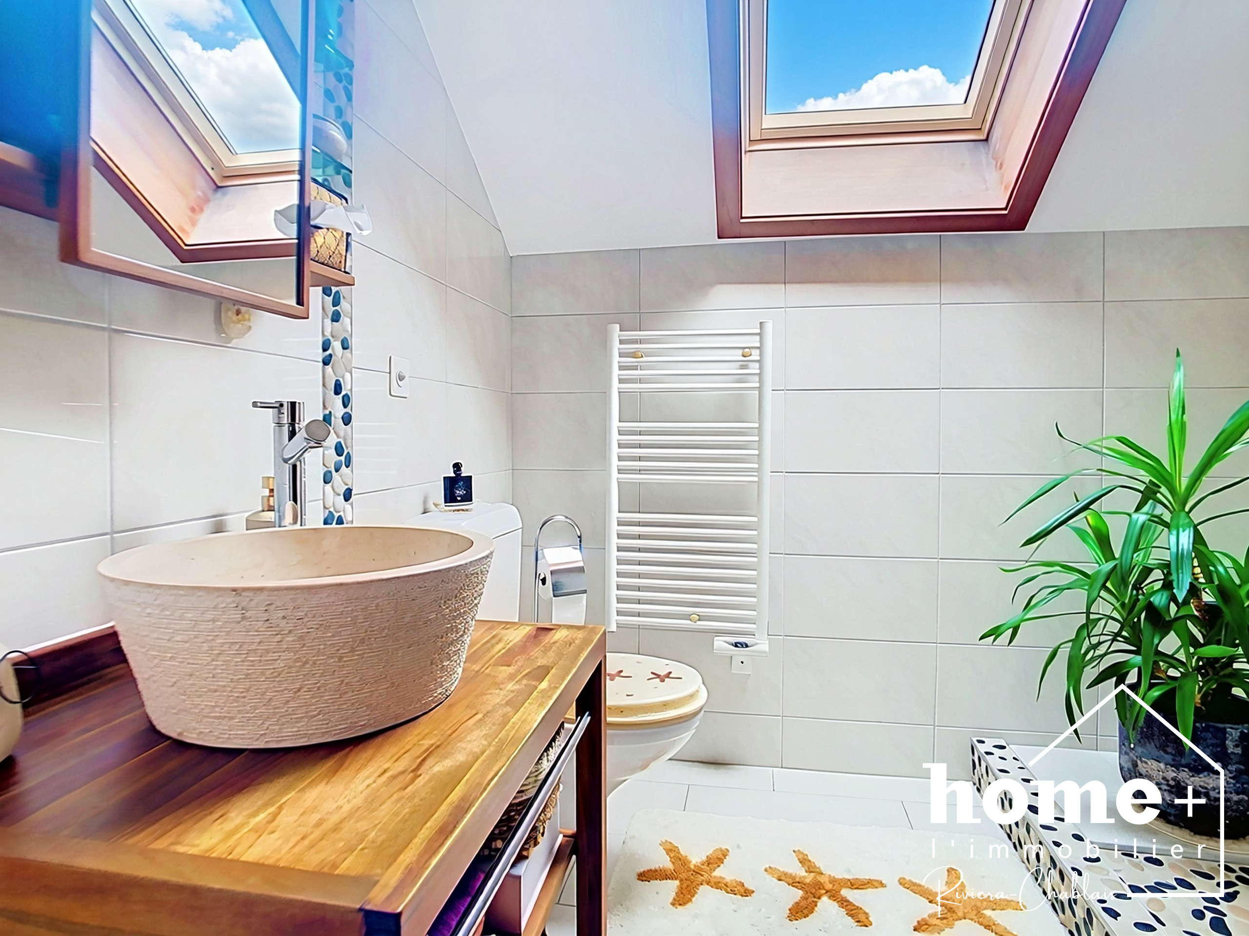 Helles Badezimmer mit Dachfenstern und Naturholz-Waschtisch