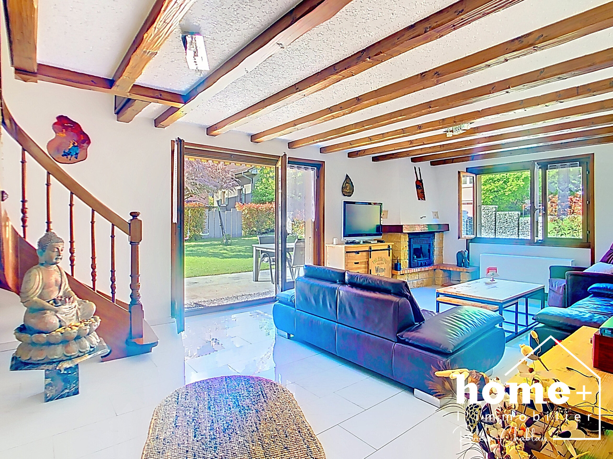 Wohnzimmer mit Holzdeckenbalken und Gartenblick