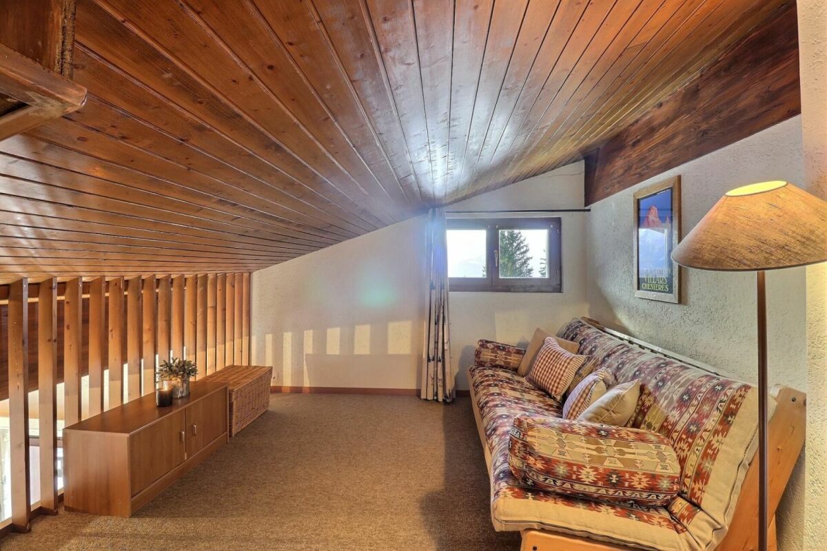 Gemütlicher Dachraum mit Holzdecke und Sitzbereich