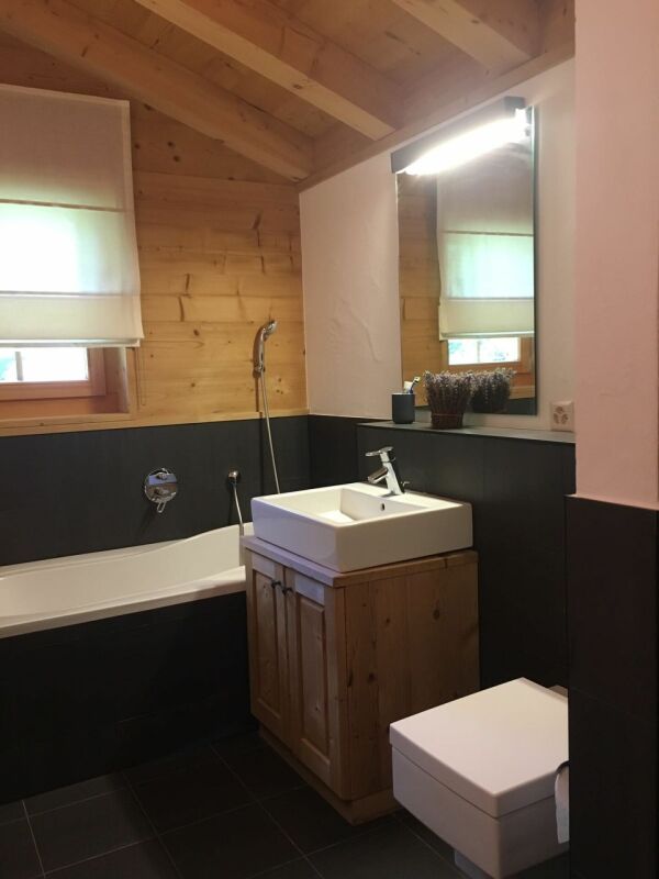 Badezimmer mit Holzverkleidung und Badewanne