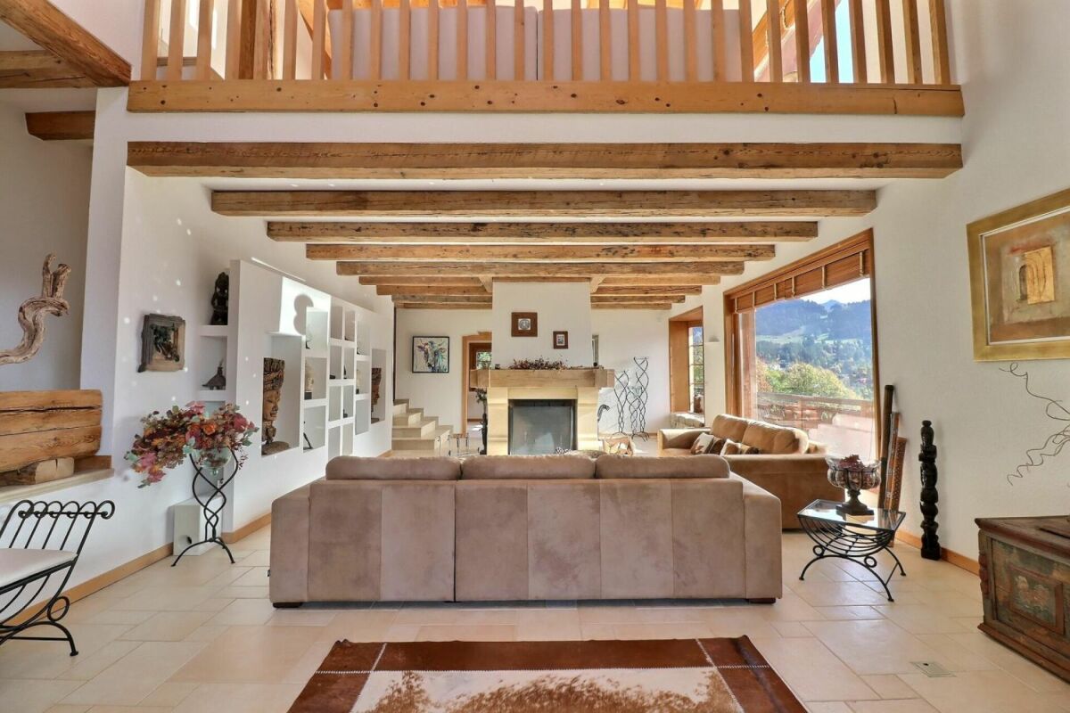 Wohnzimmer mit Holzbalkendecke und Bergblick