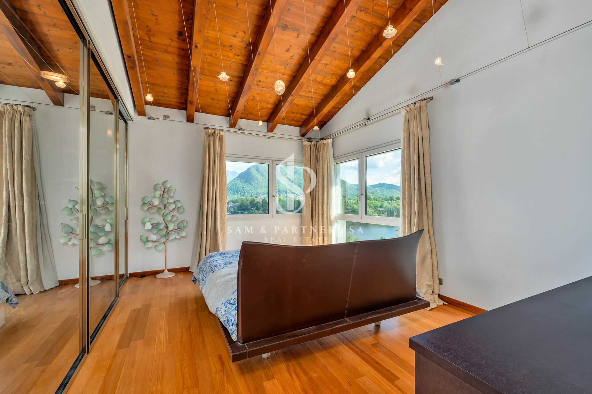 Schlafzimmer mit Holzdecke und Bergblick