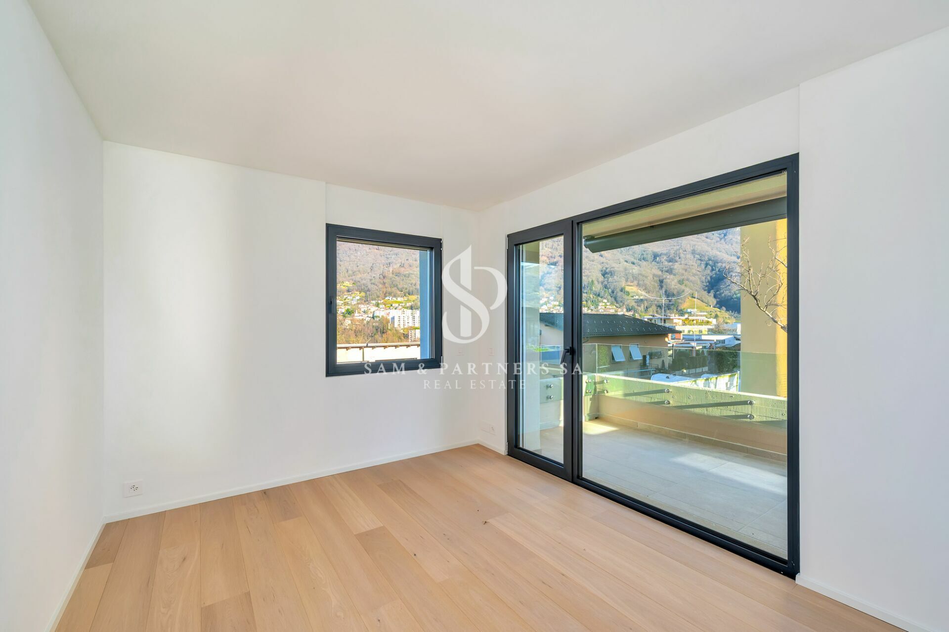 Heller leerer Raum mit Balkon- und Bergblick