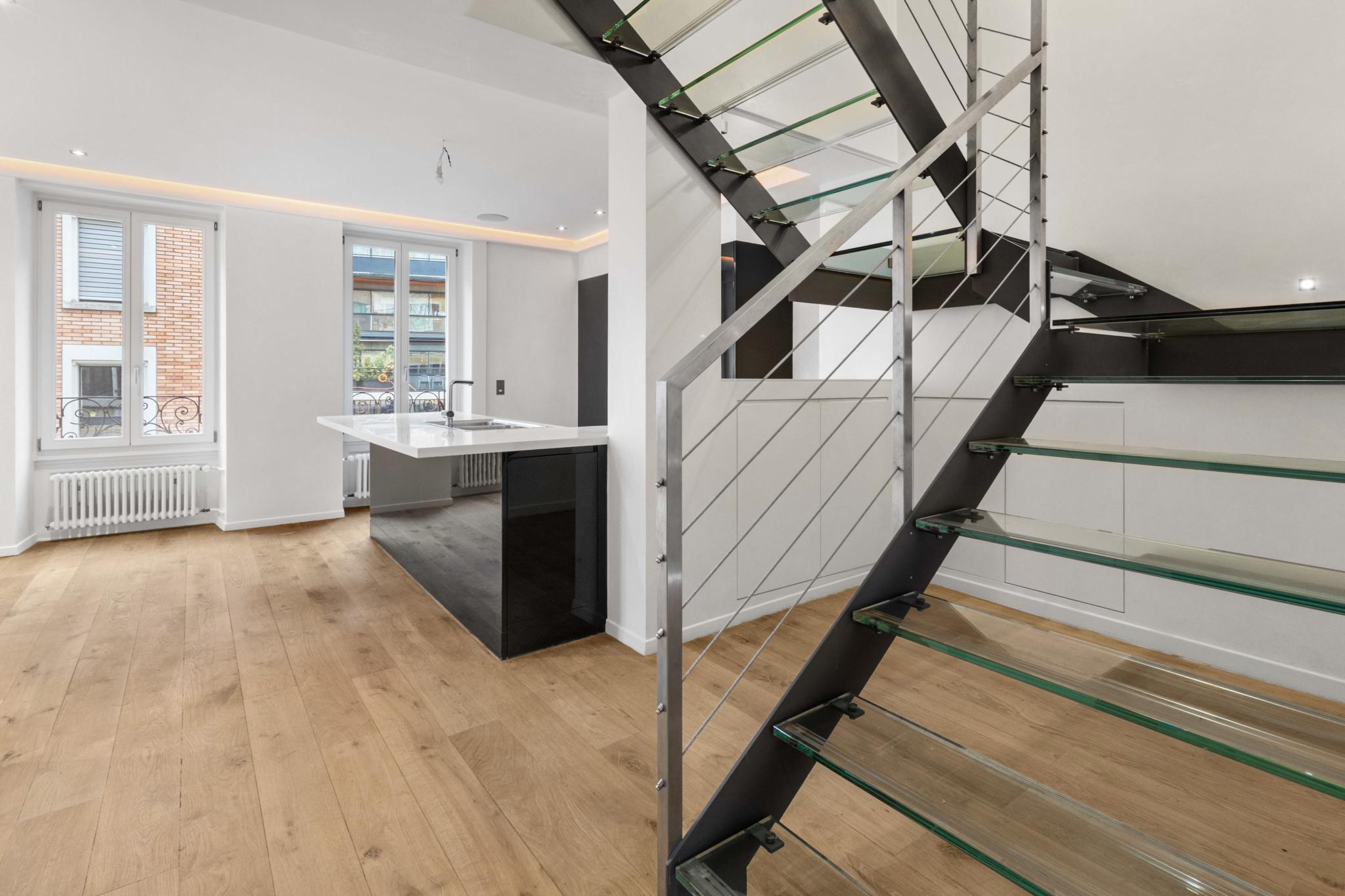 Moderne Wohnküche mit offener Treppe