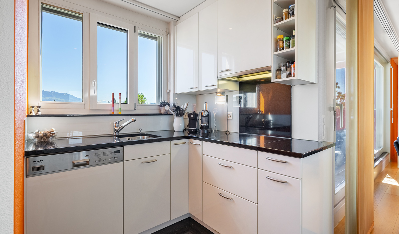 Moderne weiße Küche mit Fensterfront