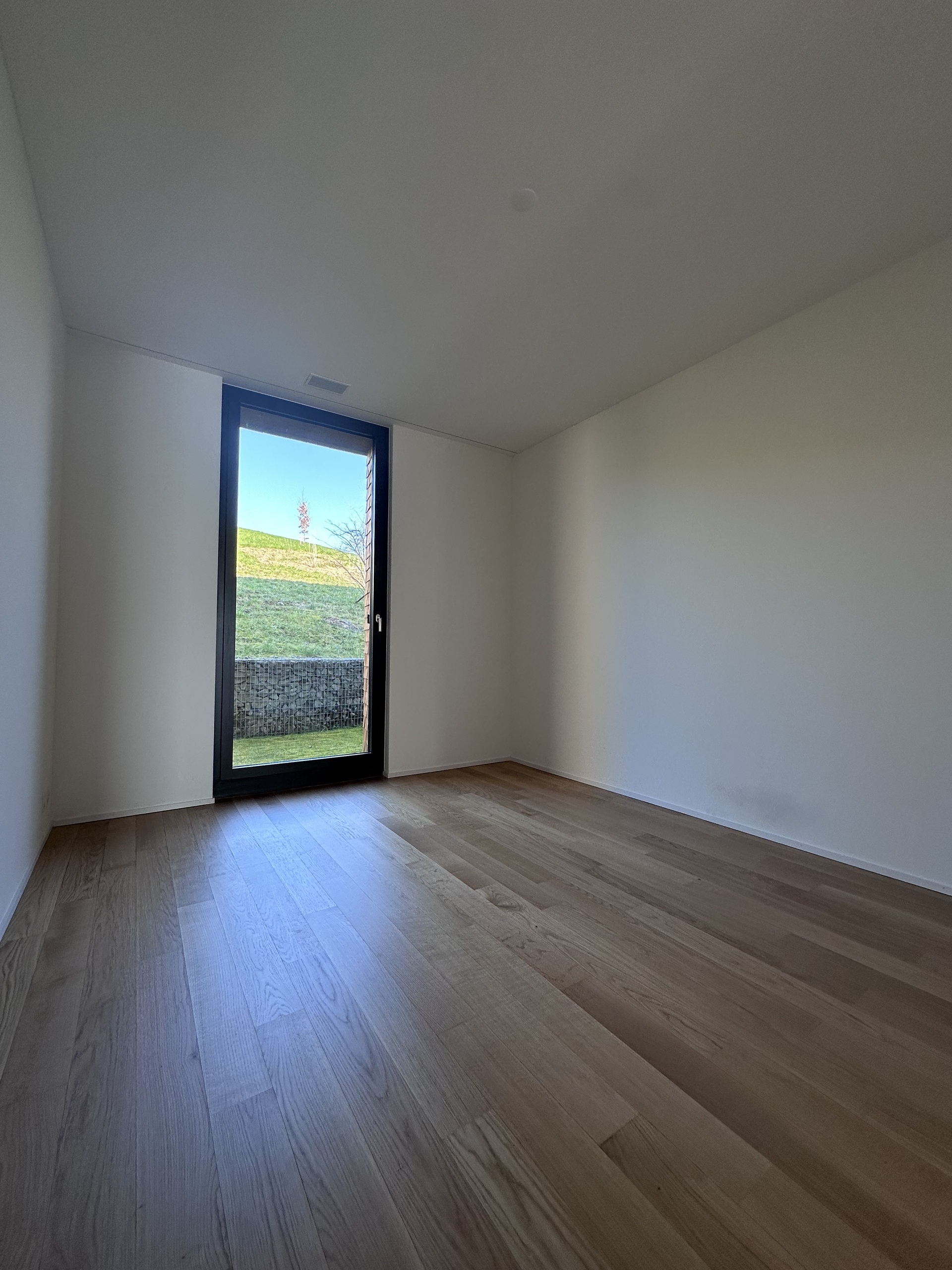 Leerer, moderner Raum mit großem Fenster