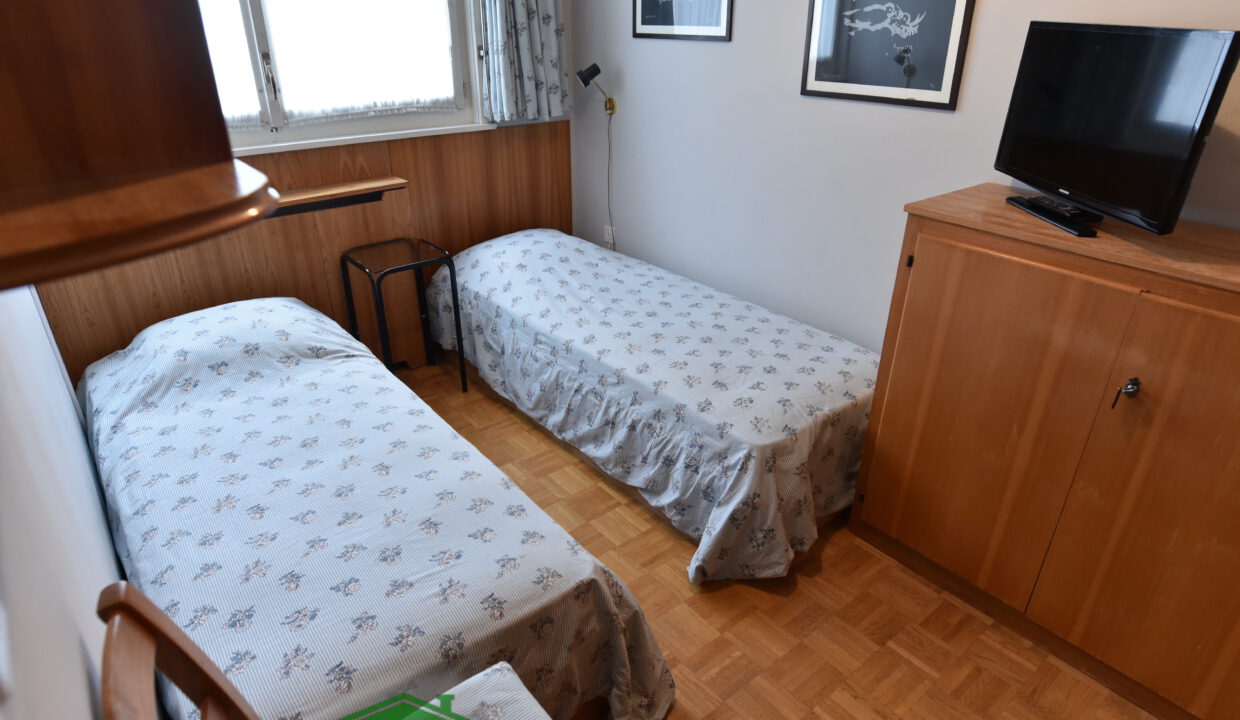Zweibettzimmer mit Holzmöbeln