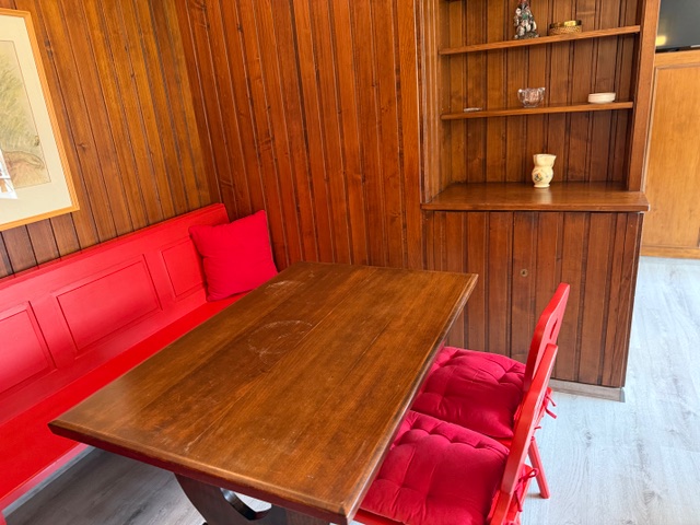 Holzvertäfelte Sitzecke mit roter Bank