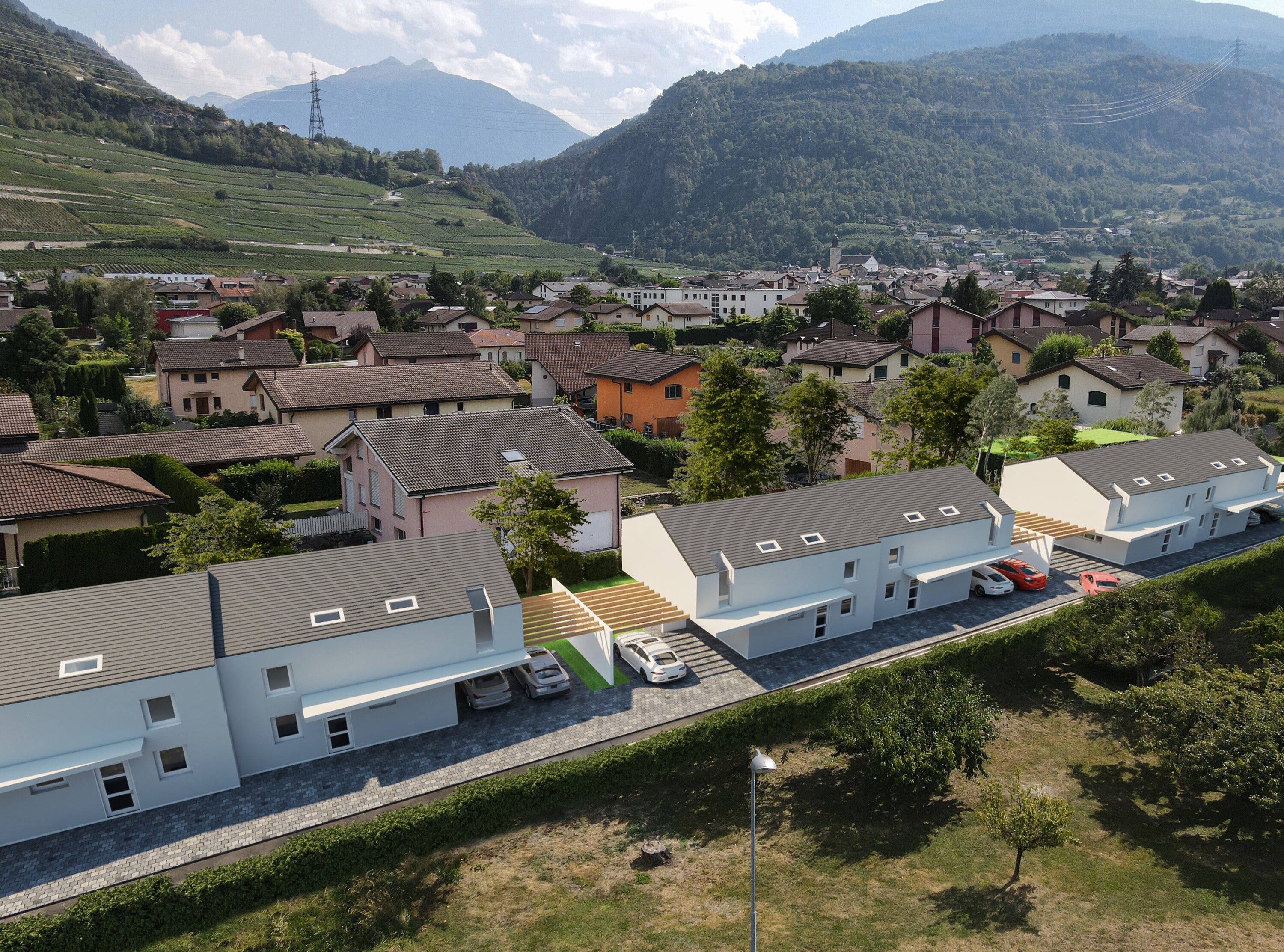 Luftaufnahme einer Wohnsiedlung in alpiner Tallage