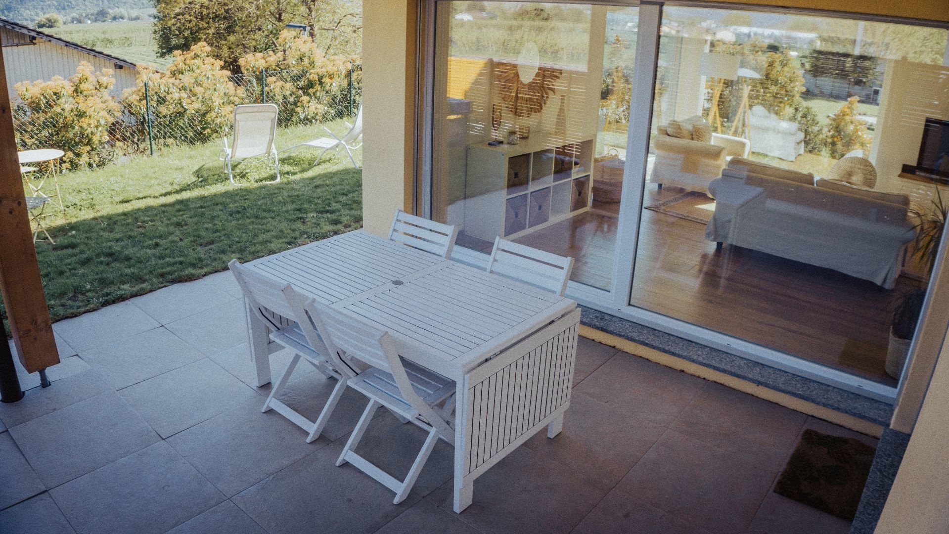 Überdachte Terrasse mit Blick ins Wohnzimmer und in den Garten