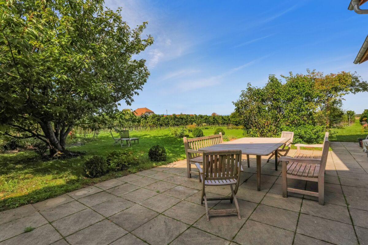 Terrasse mit Gartenmöbeln und großem Garten