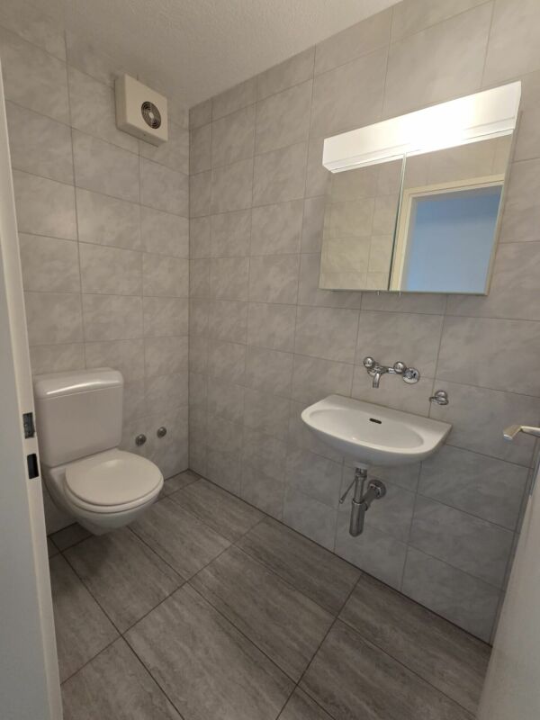 Gäste-WC mit Fliesen und Wand-WC