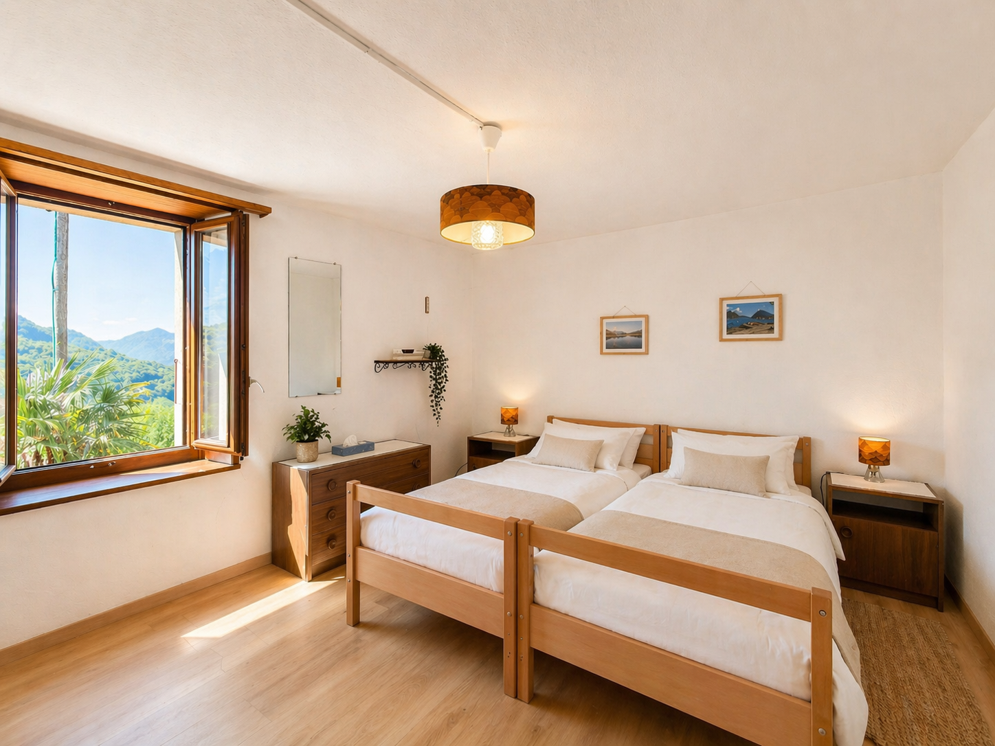 Helles Schlafzimmer mit Doppelbett und Bergblick