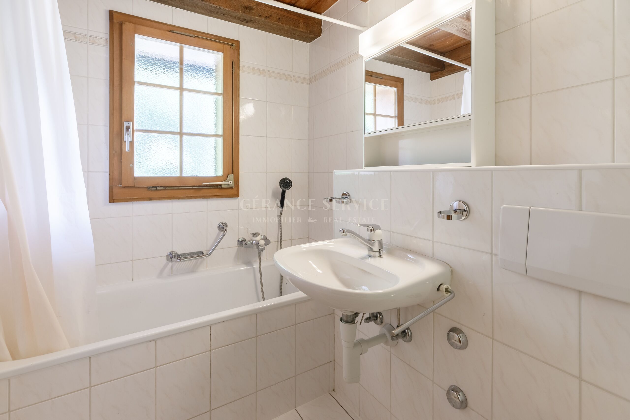 Helles Badezimmer mit Badewanne und Fenster