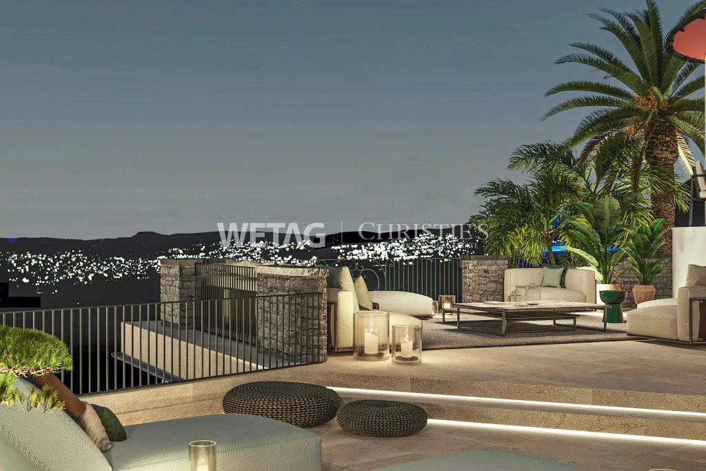 Dachterrasse mit Lounge und Panoramablick bei Nacht