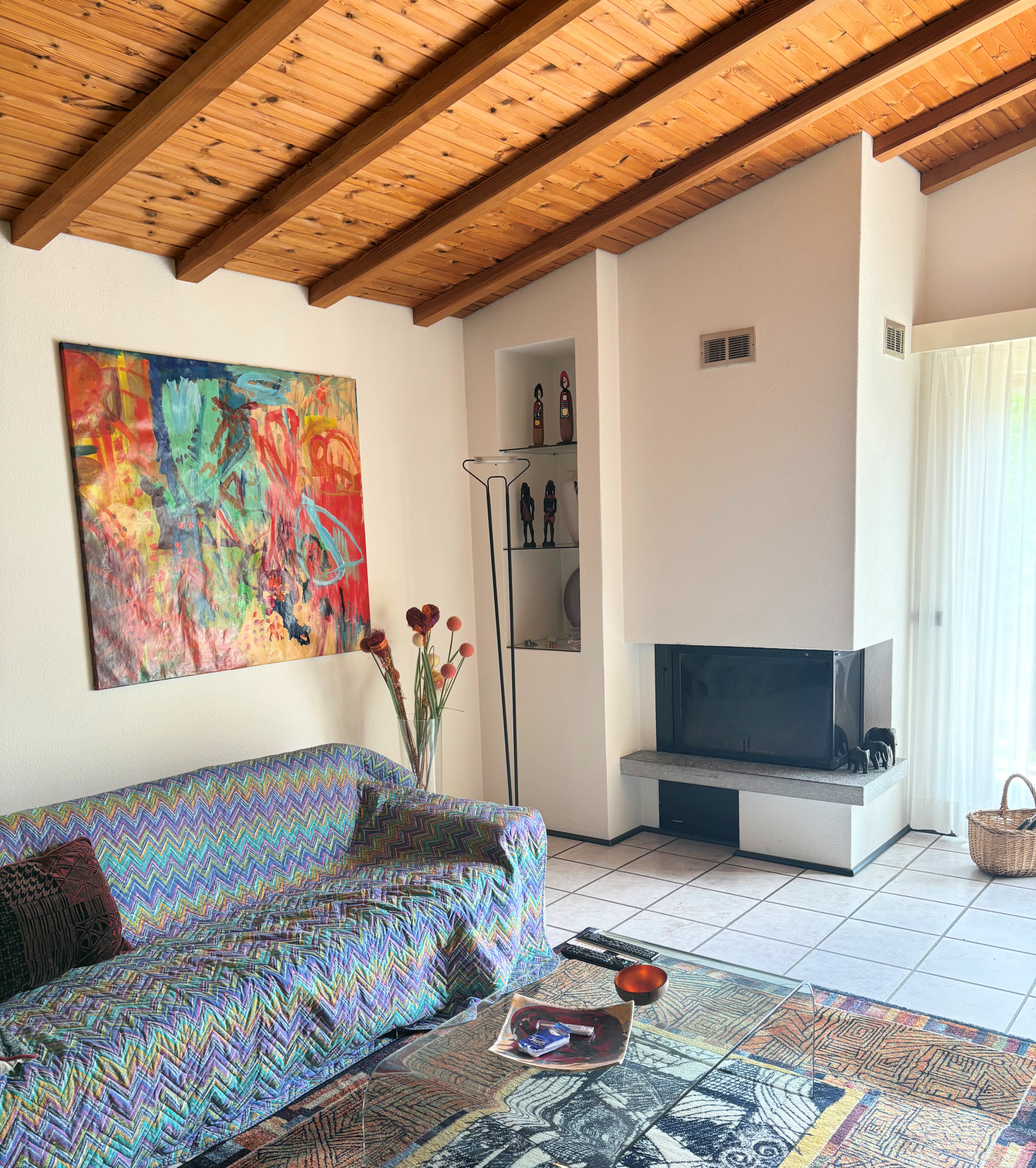 Wohnzimmer mit Kamin und Holzbalkendecke